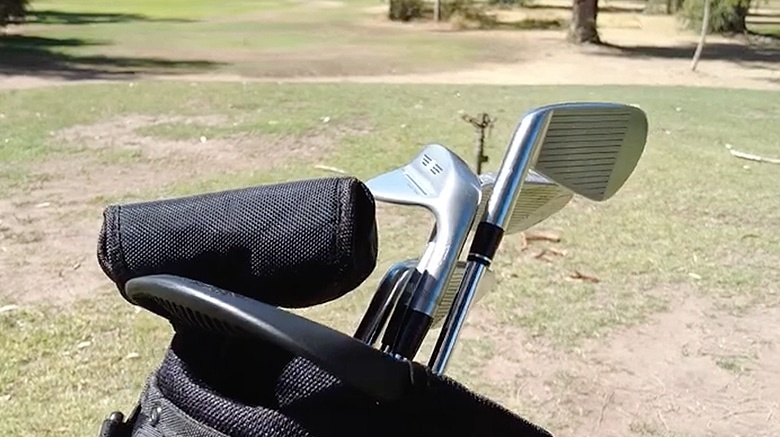 Golf clubs in a bag on grassy course