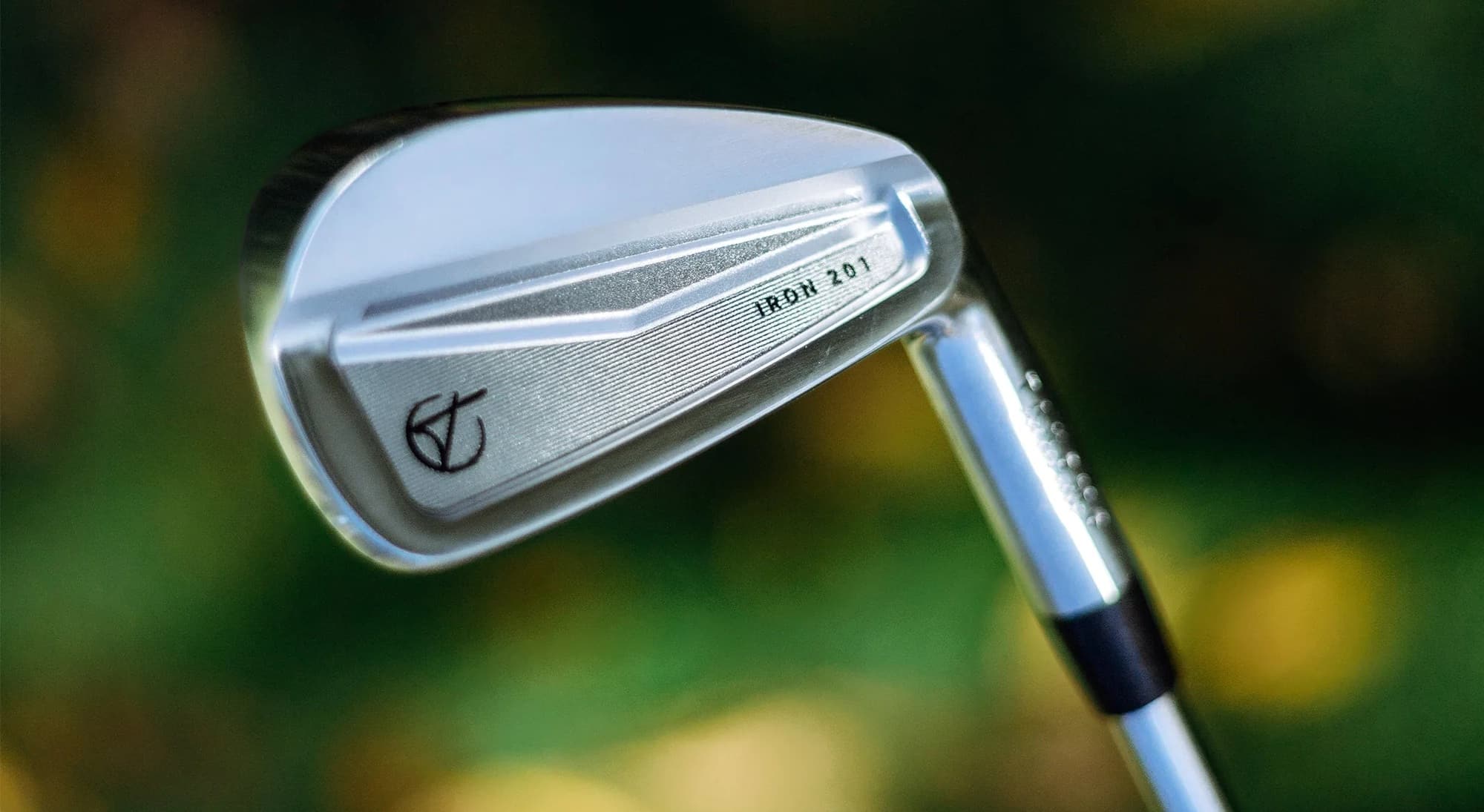 Close-up of a silver golf iron club.