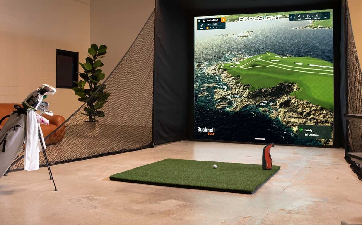 Indoor golf simulator setup with screen and mat