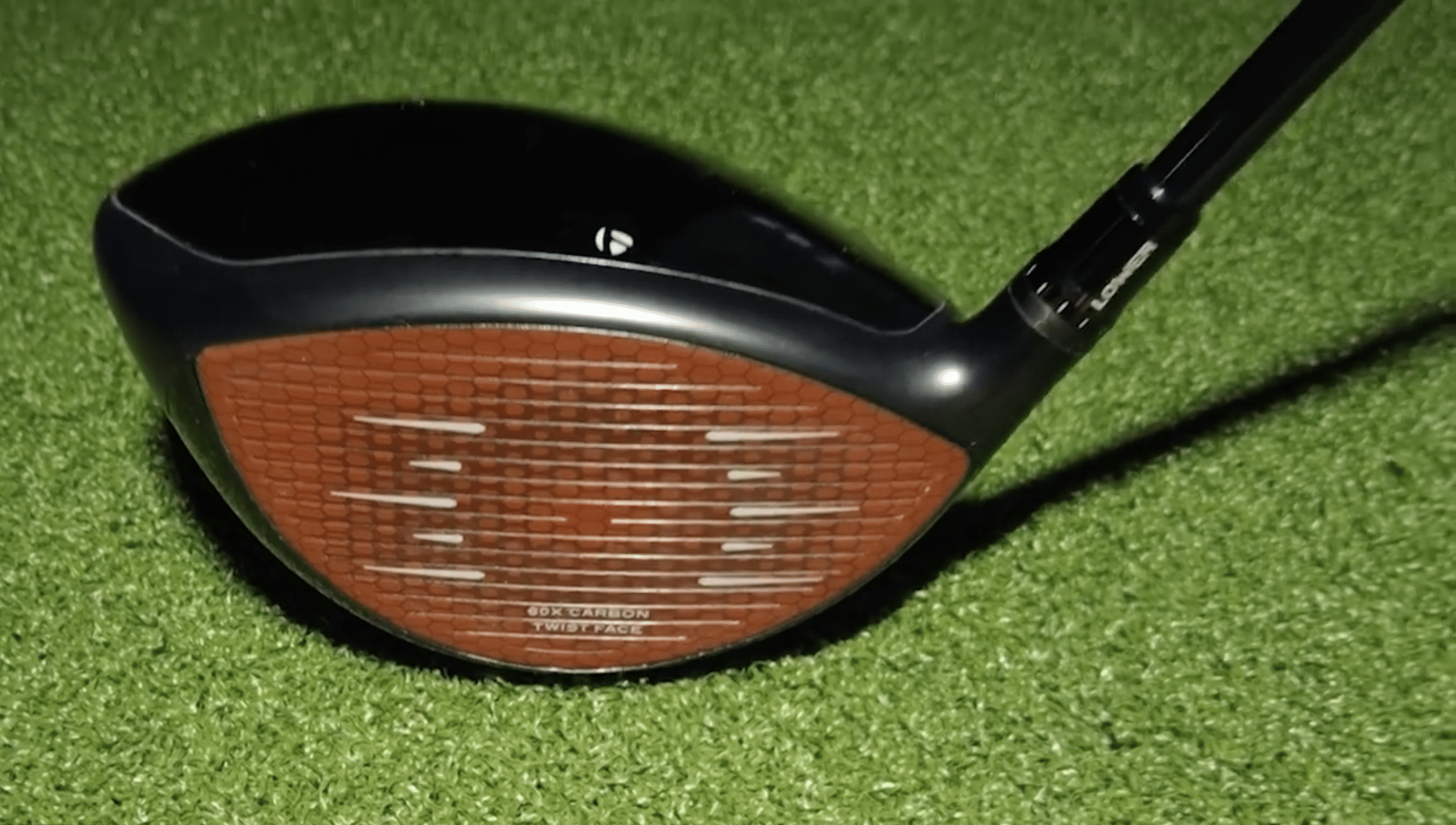 Golf driver club on green turf