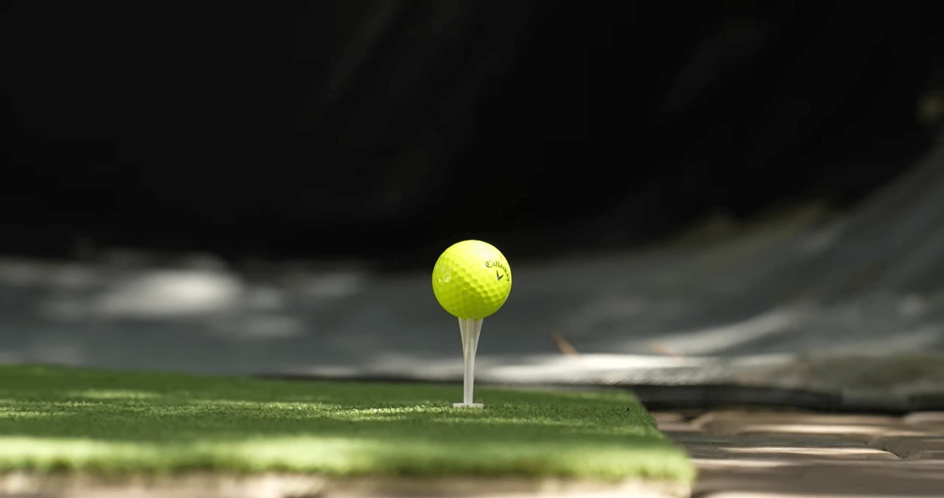 Yellow golf ball on tee