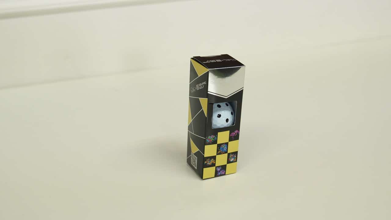 Square Golf marked golf ball retail box with the ball visible through the window