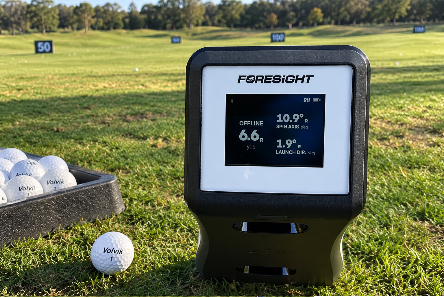 Foresight golf launch monitor beside balls at driving range
