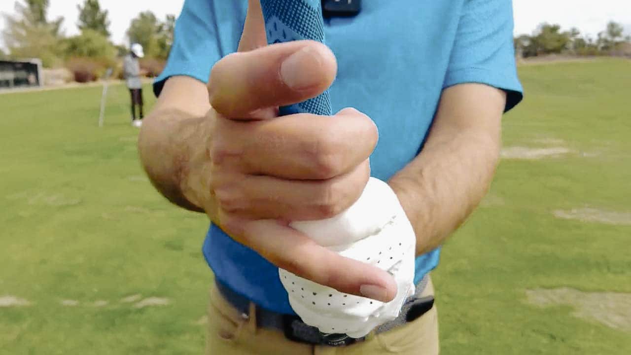 Close-up of a golfer's grip on a club.