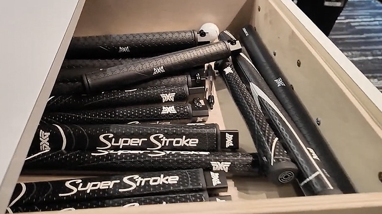 Assorted golf putter grips in a drawer.