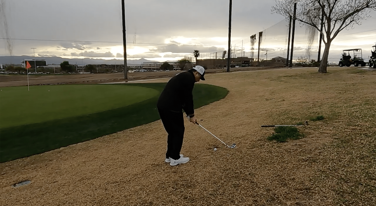 Golfer preparing to swing on the course.