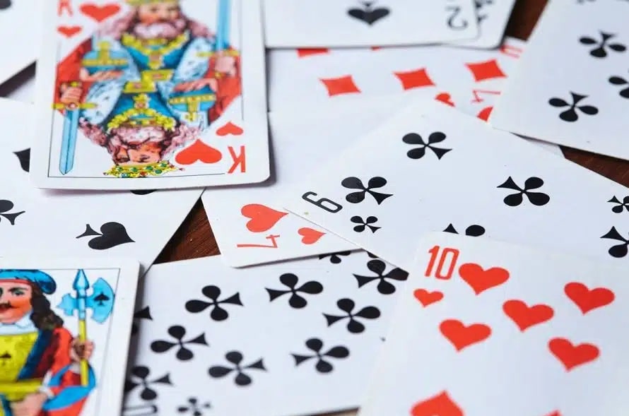 Various playing cards scattered on a table.