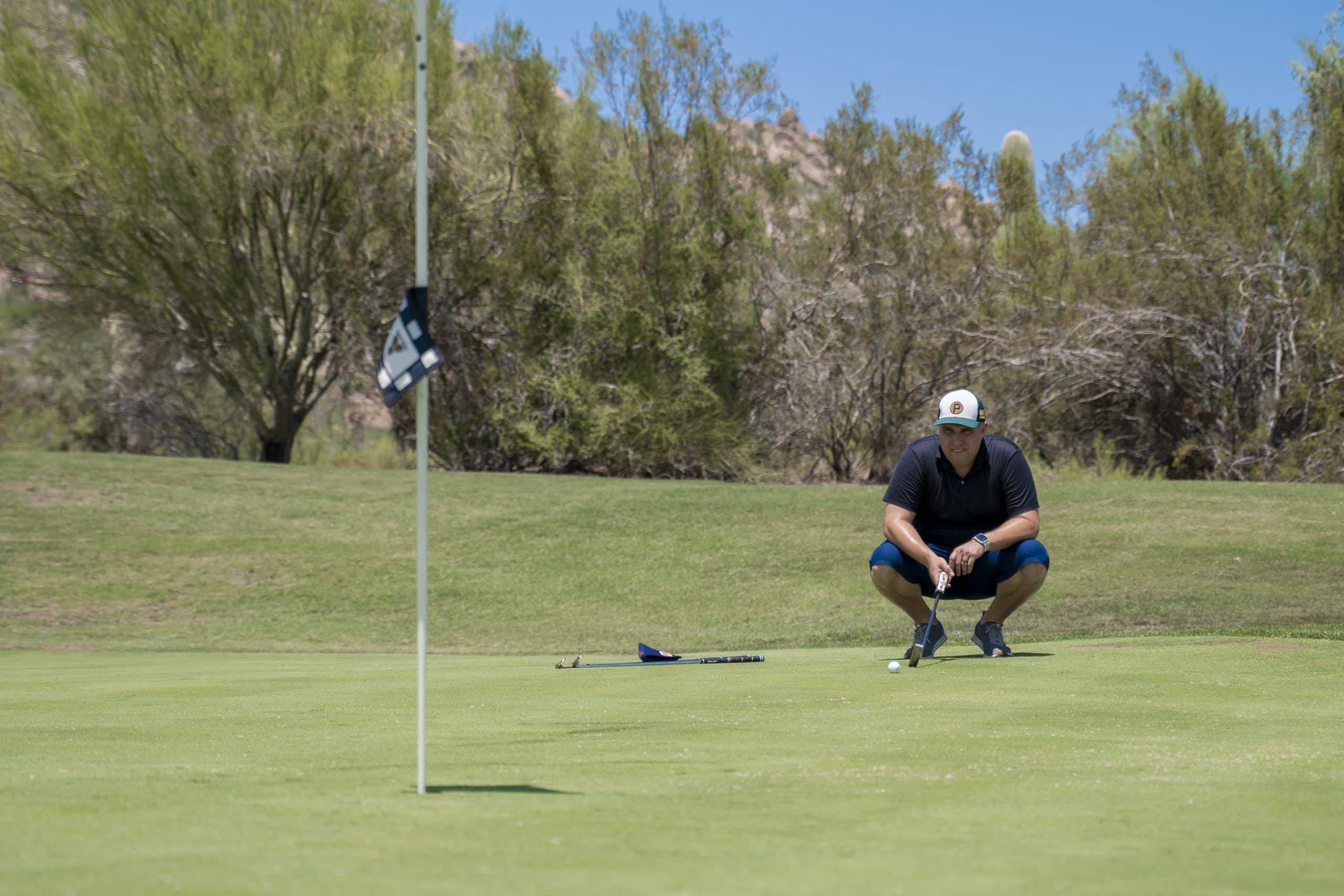 Golfer preparing to putt on the green