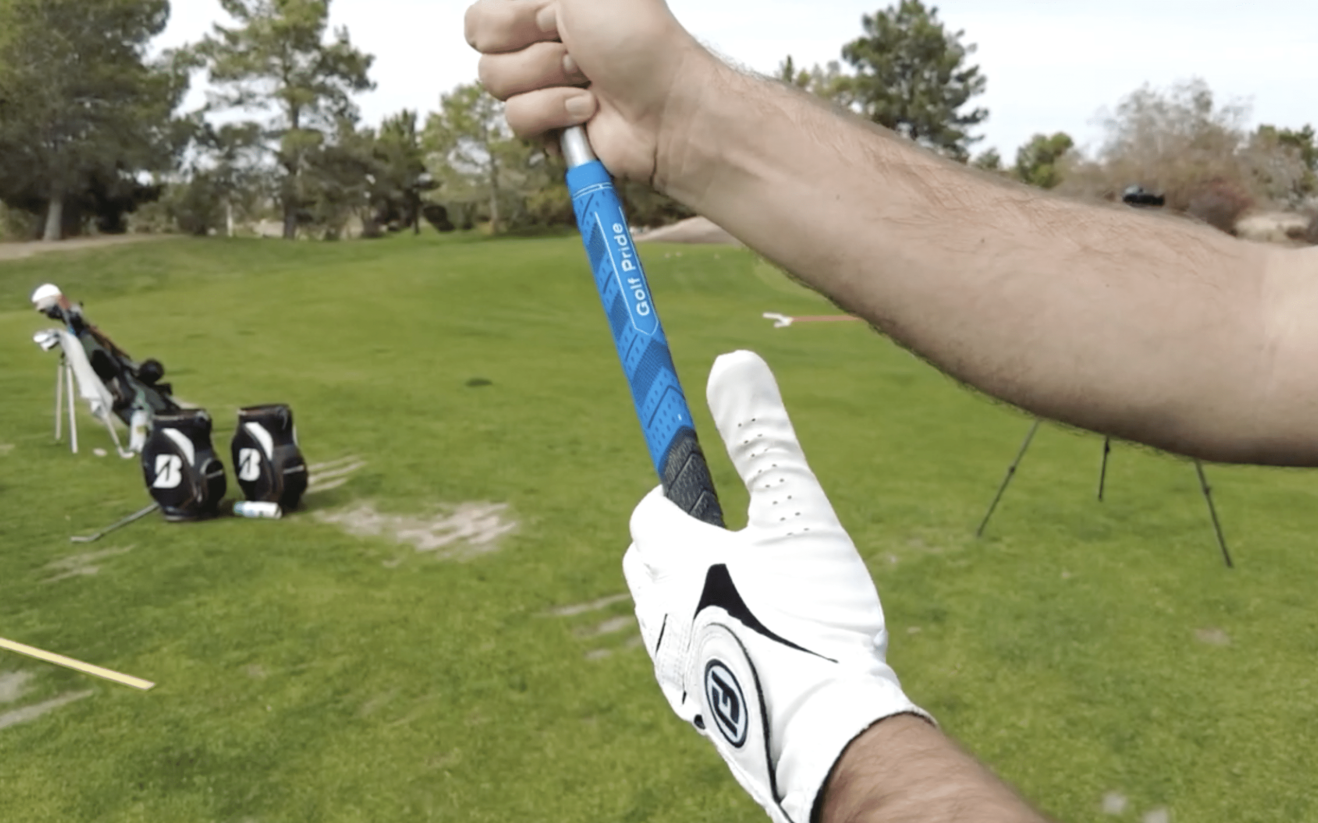 Close-up of a golfer gripping a club.