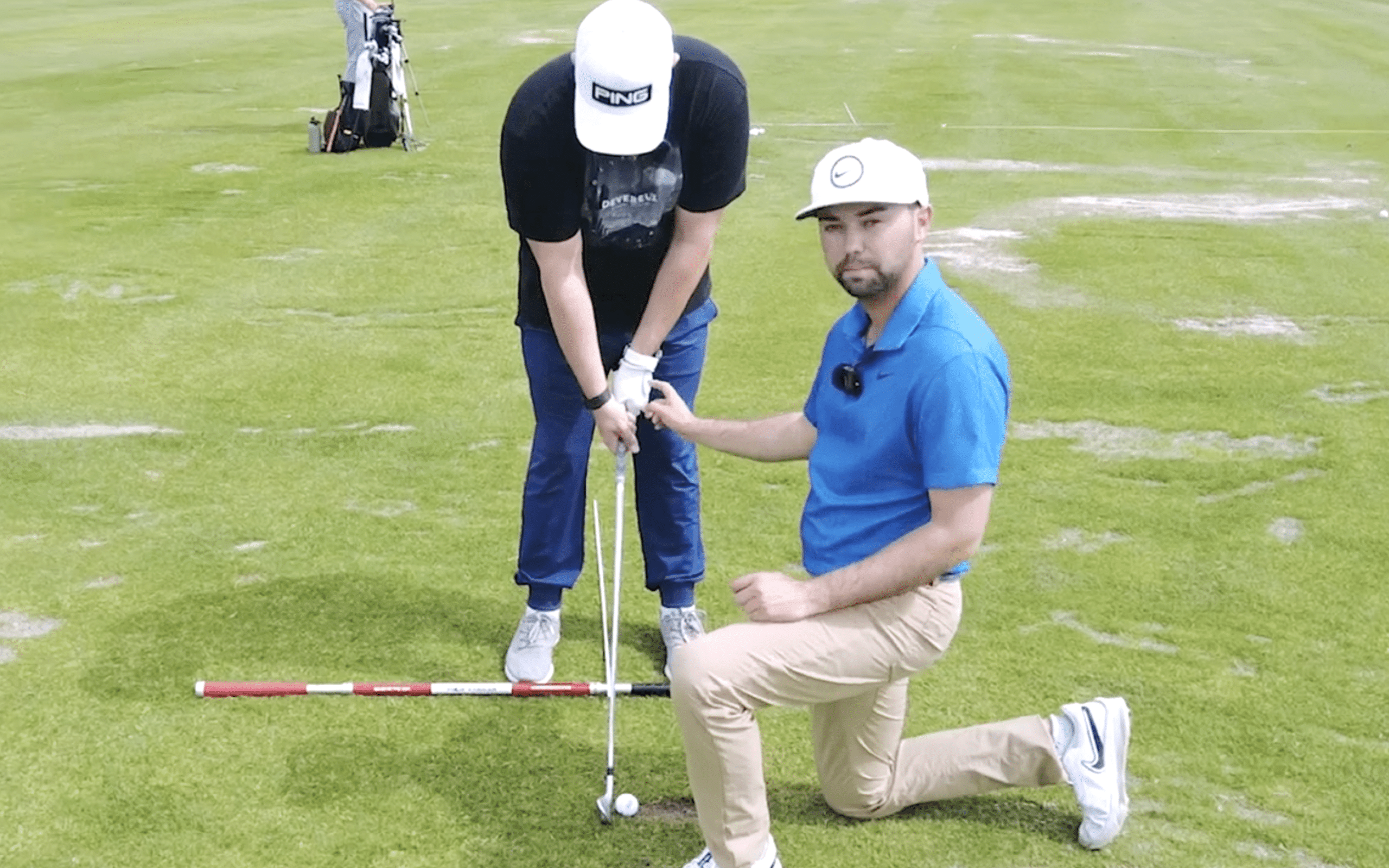 Two golfers practicing techniques on the green.