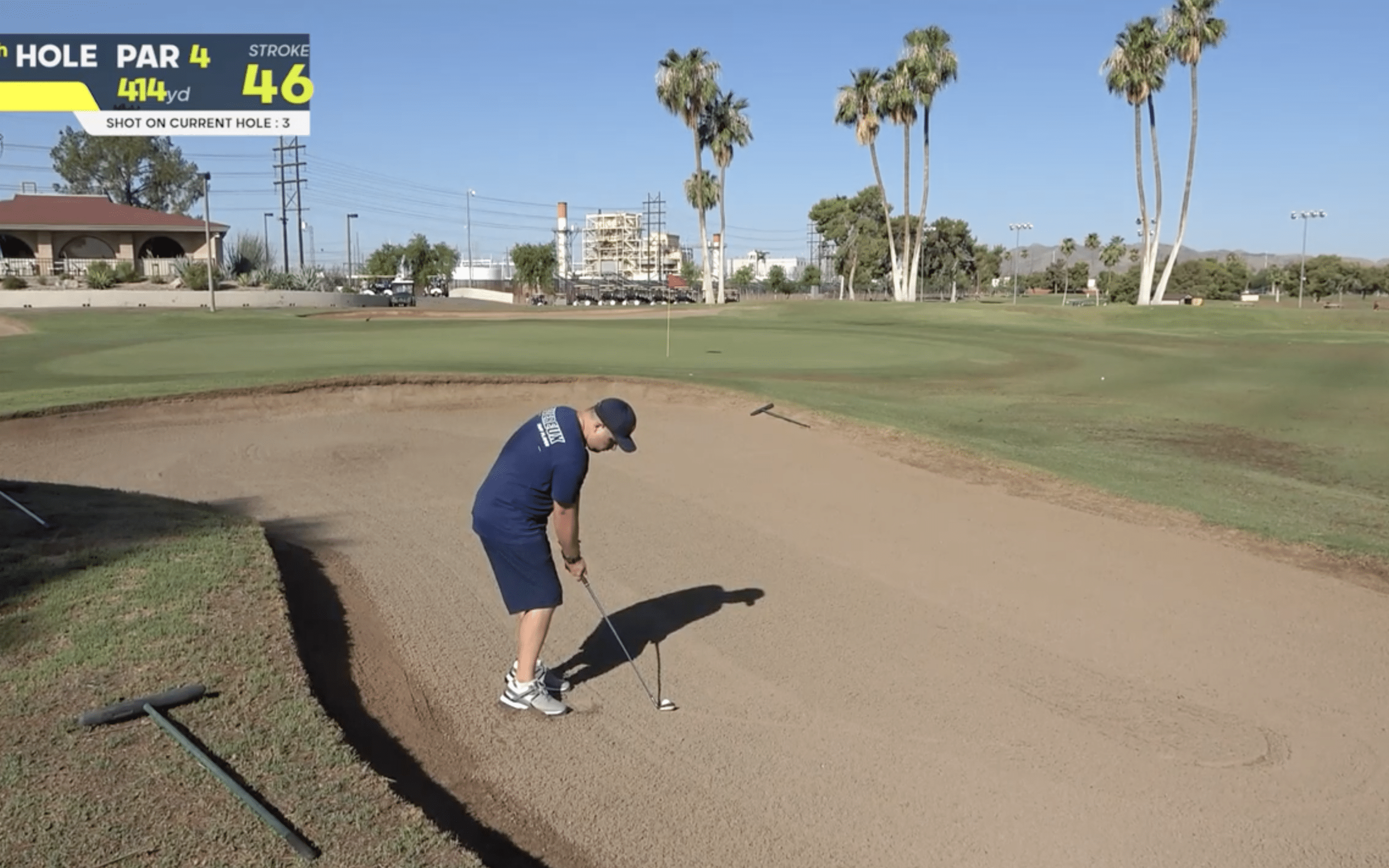 Golfer preparing to hit from a sand trap.