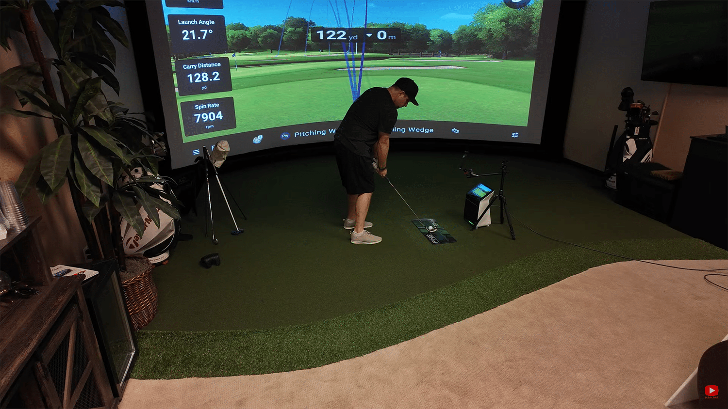 Golfer practicing swing in virtual golf simulator.