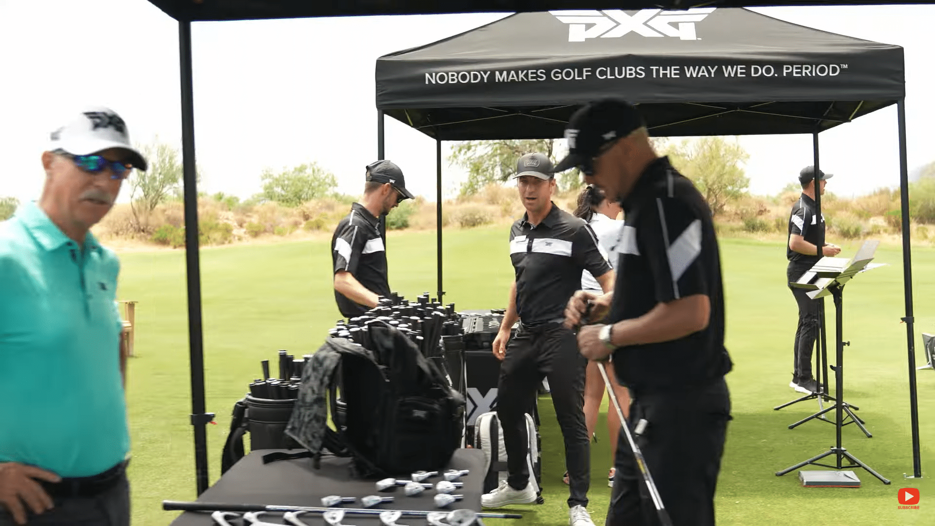 Golf event showing PXG staff and equipment setup.