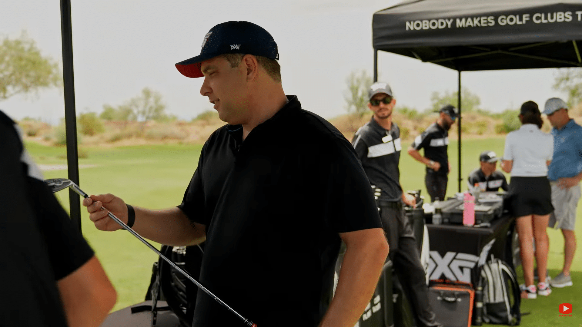 Golf equipment demonstration at outdoor event