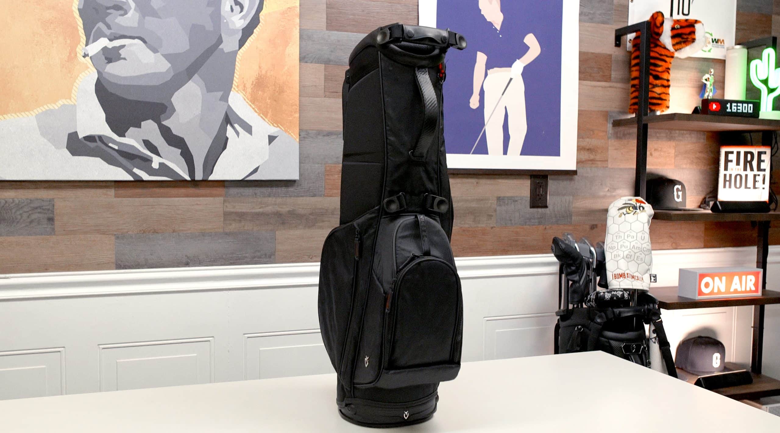 Black golf bag displayed on a table