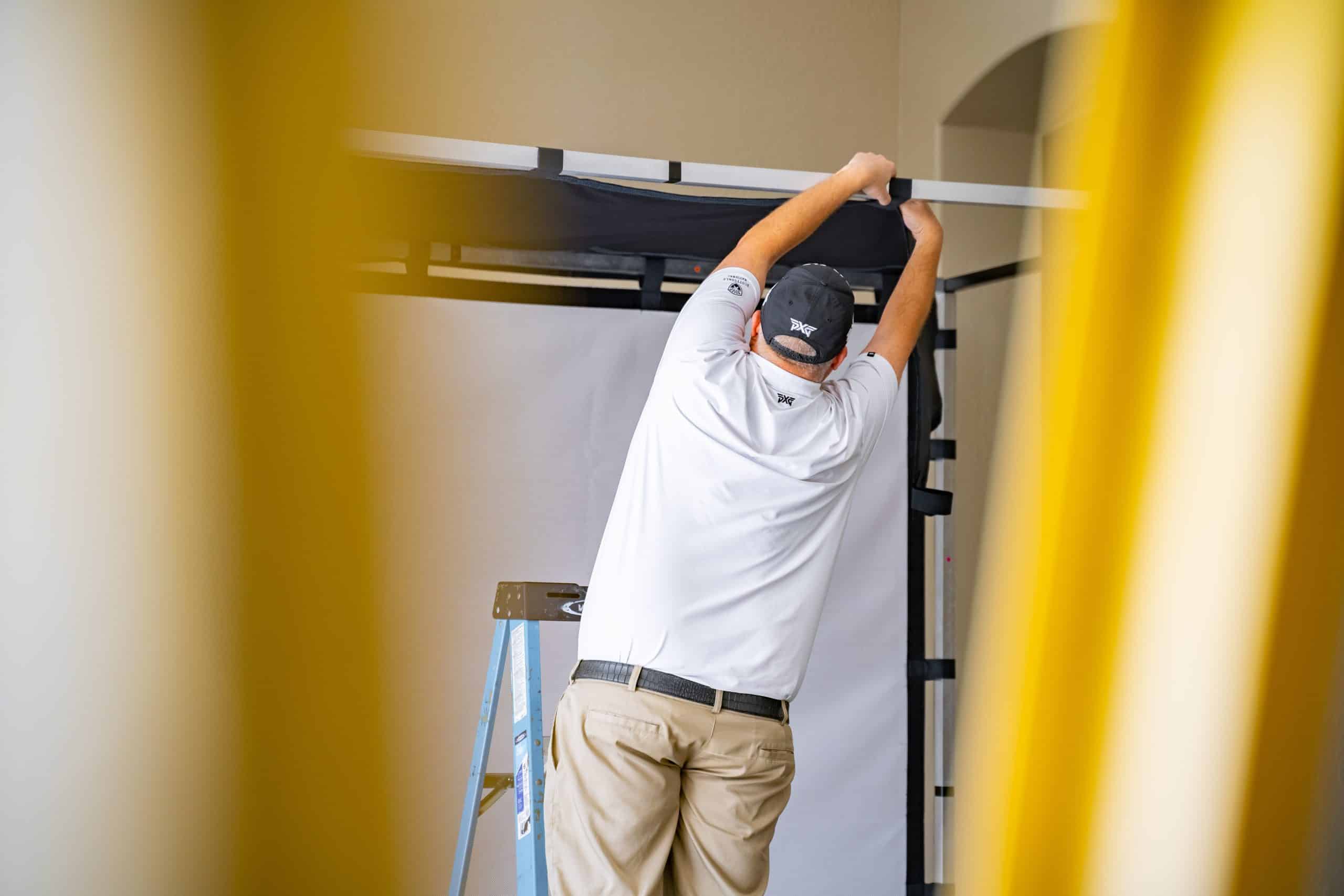 Man setting up indoor frame structure