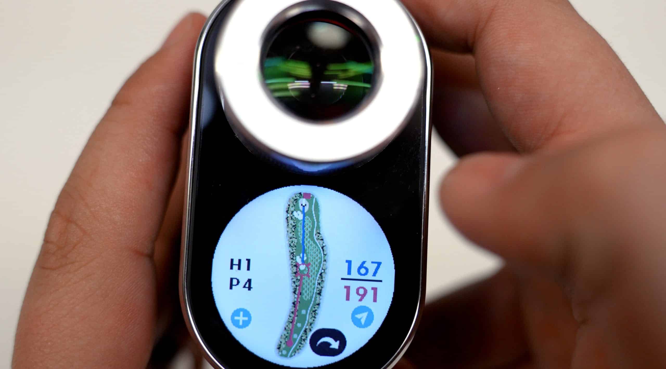 Hand holding golf rangefinder with course map