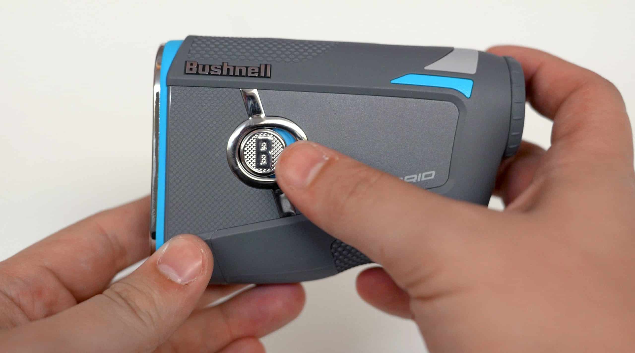 Person holding a Bushnell golf rangefinder