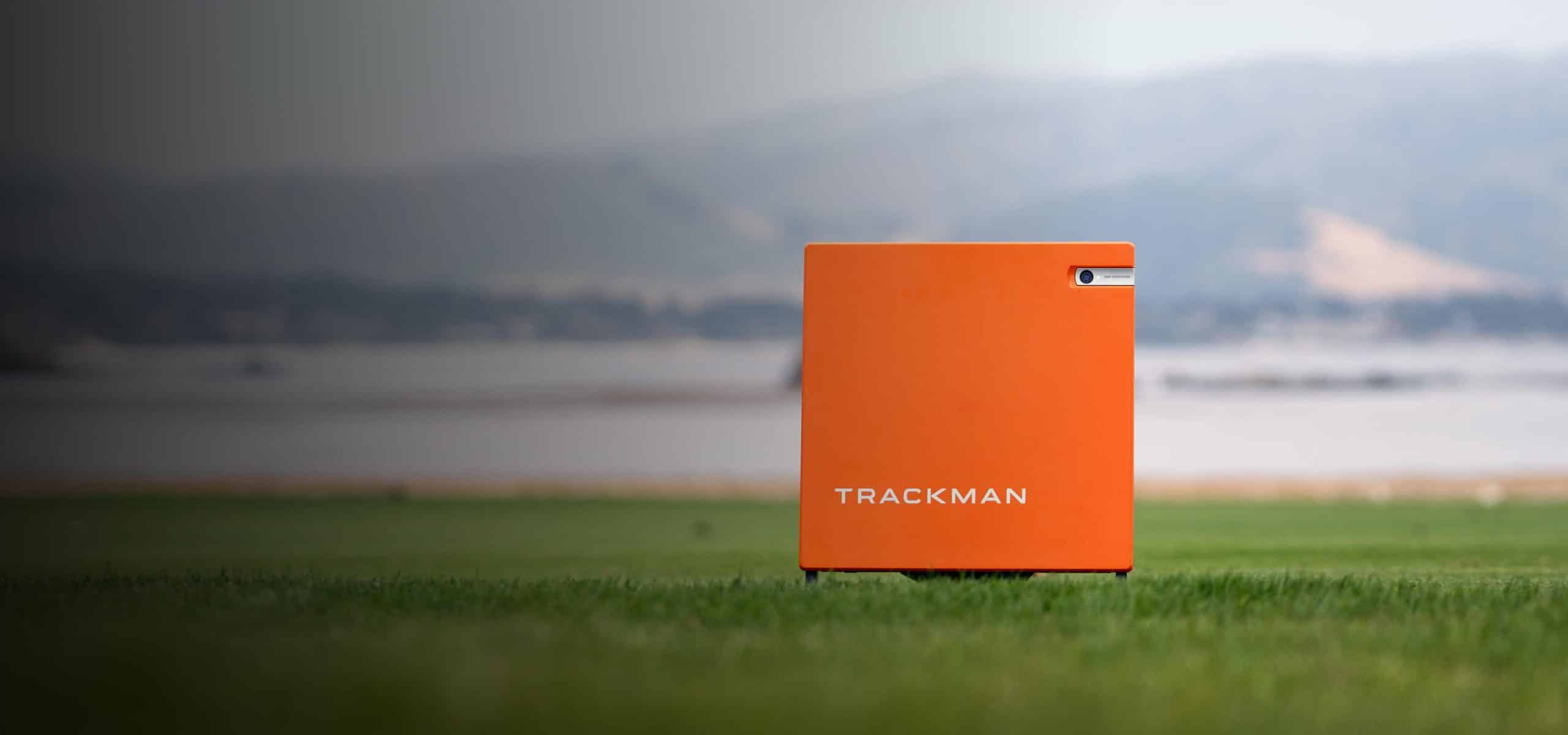 TrackMan golf launch monitor on grass field