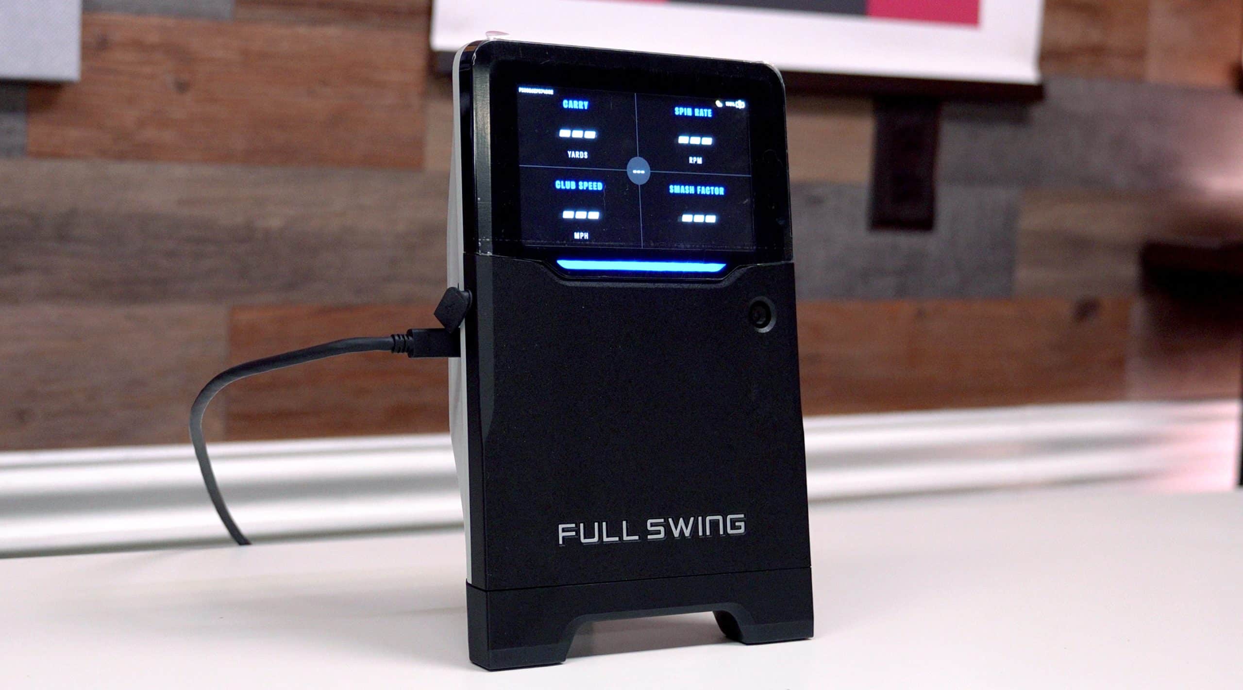 Full Swing golf launch monitor on white table