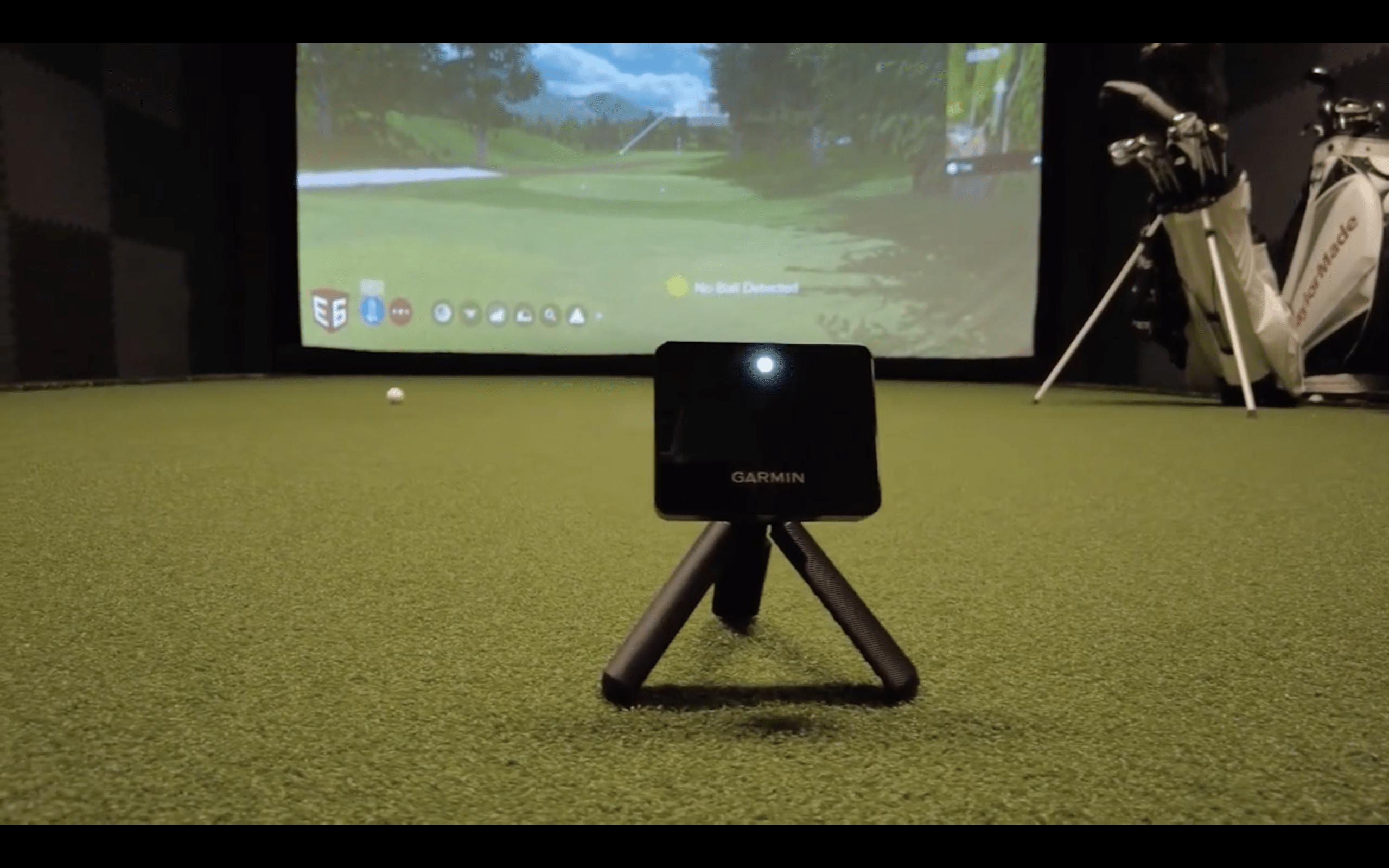 Garmin golf launch monitor in indoor simulator setup