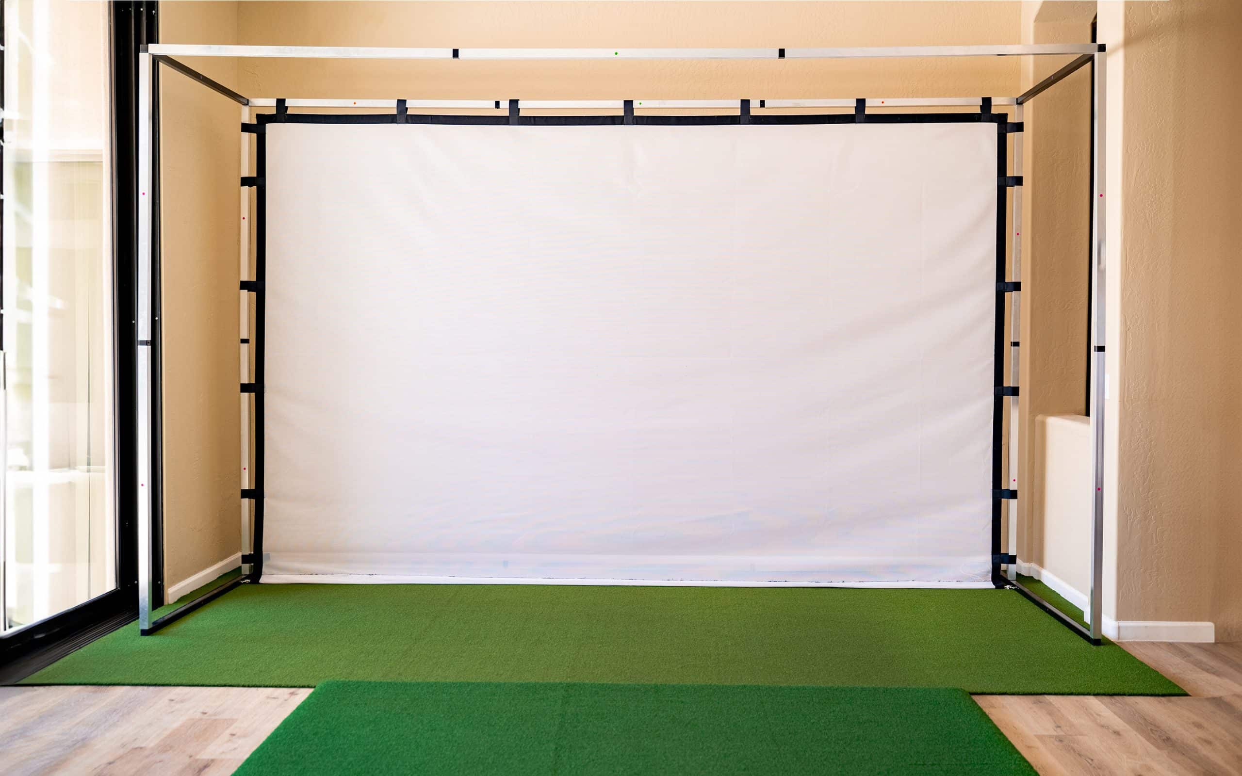Indoor golf simulator with hitting screen and turf