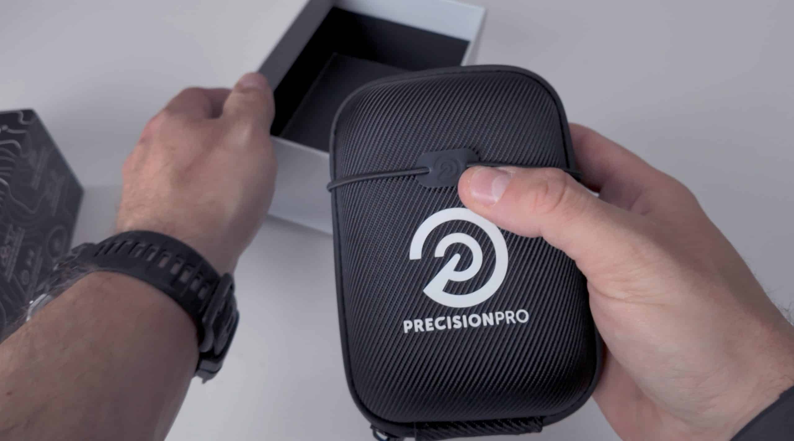 Person holding Precision Pro black carrying case