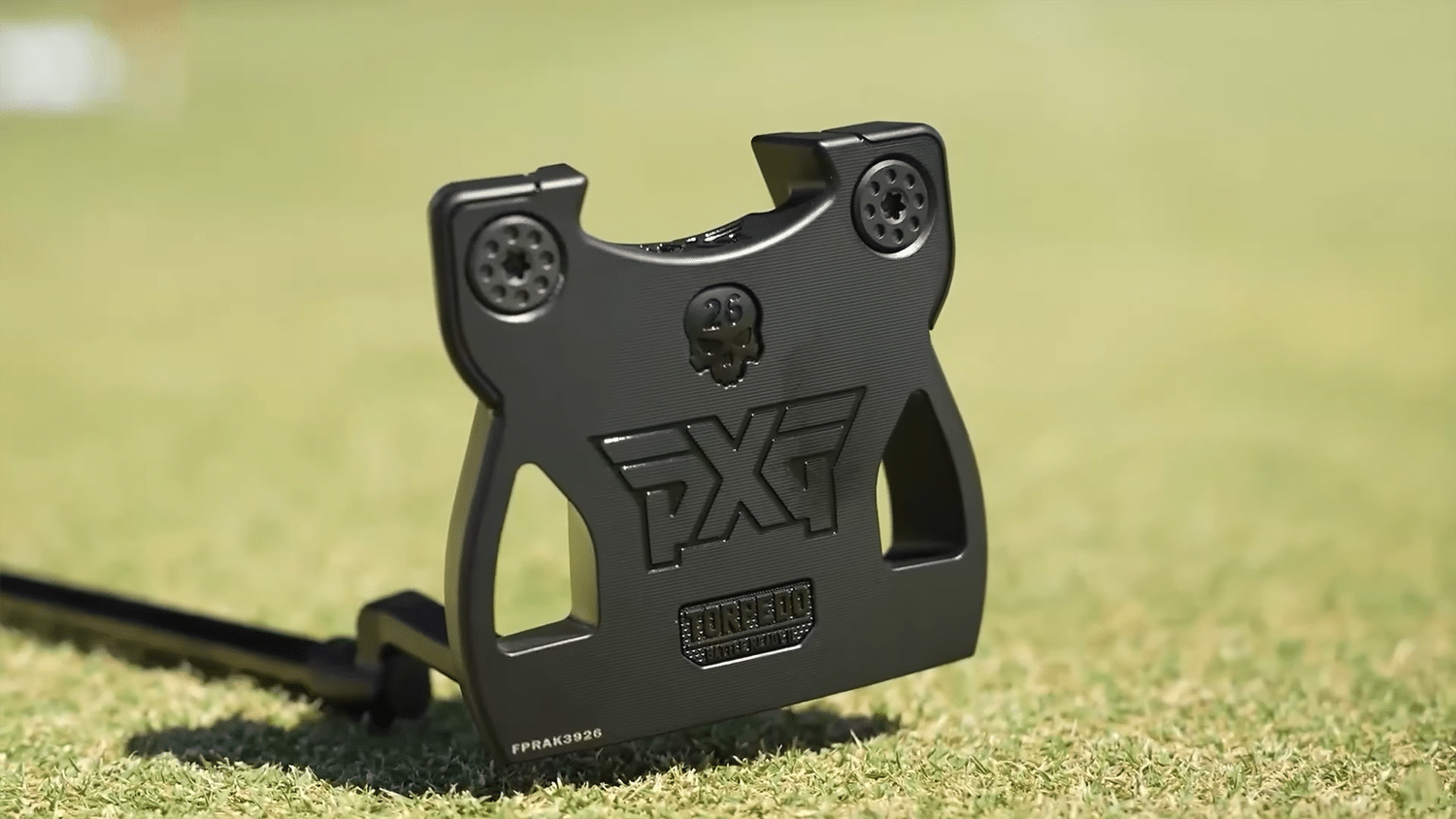 Black PXG golf putter on grass surface