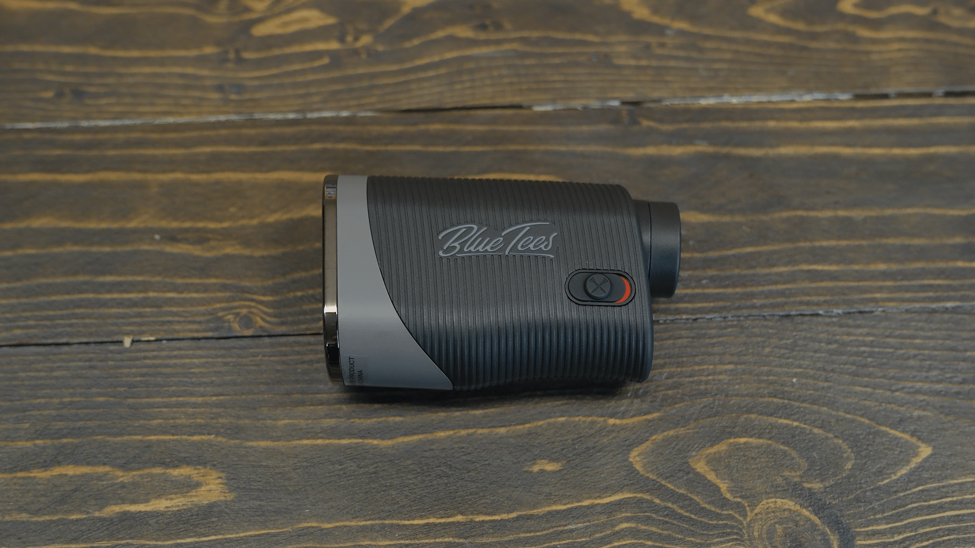 Blue Tees golf rangefinder on wooden surface