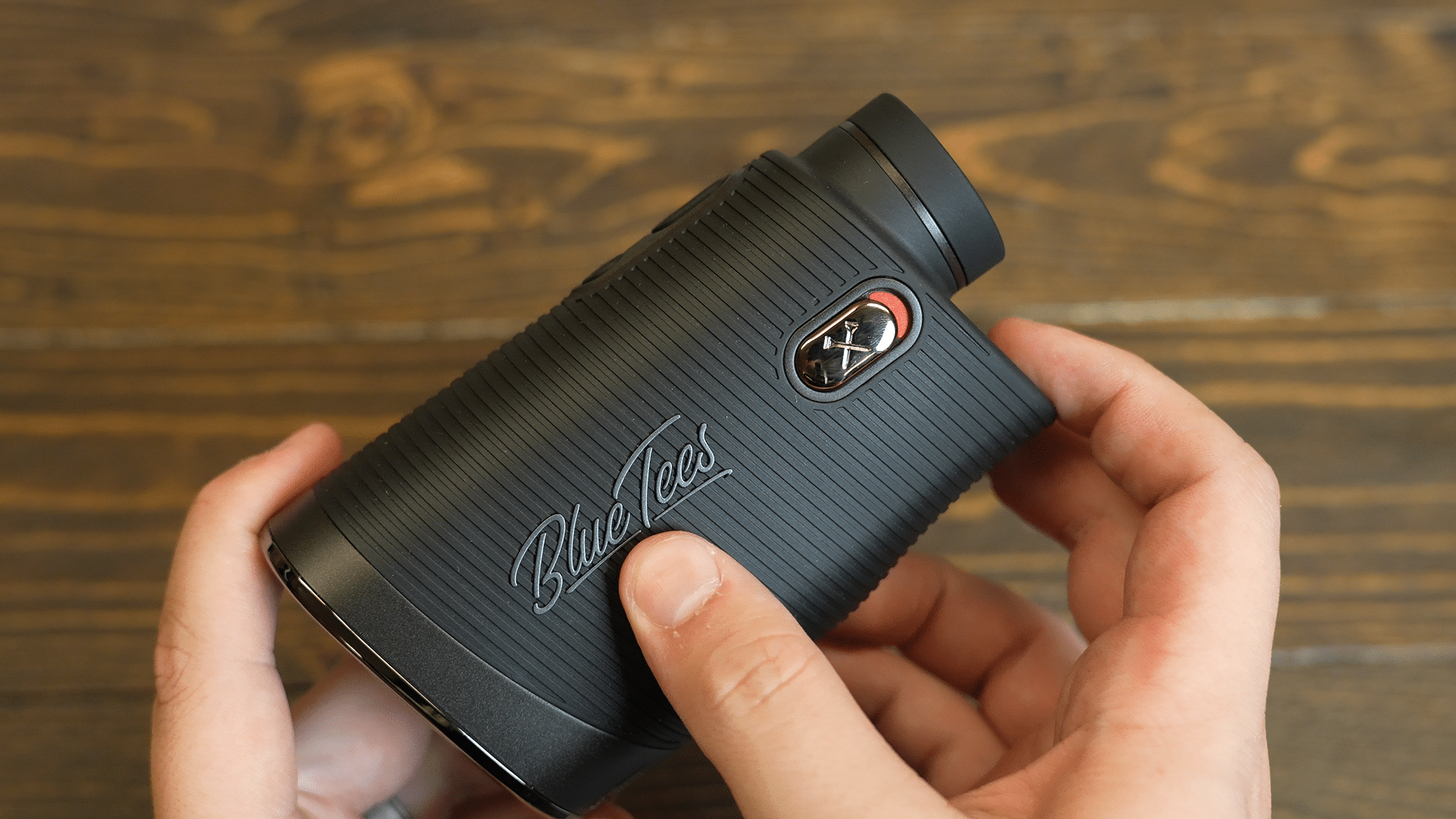 Person holding Blue Tees golf rangefinder device