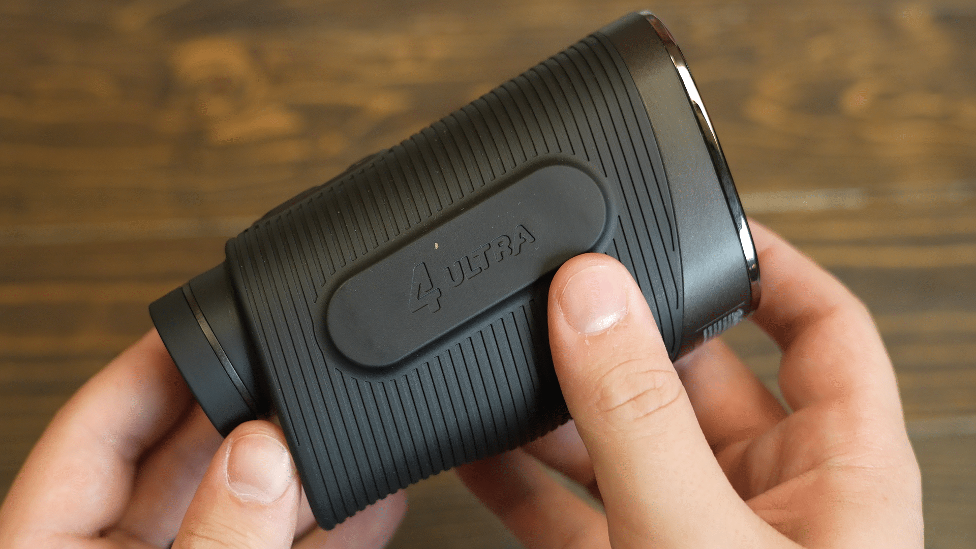Person holding black portable speaker