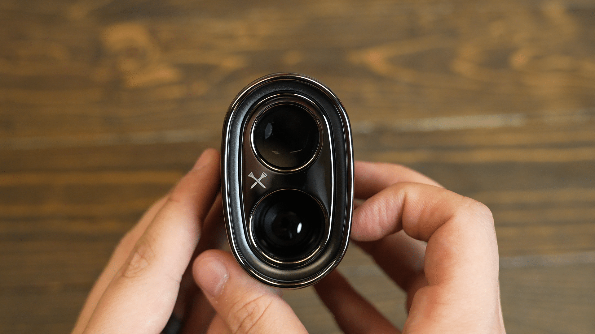 Close-up of dual-lens camera device in hands