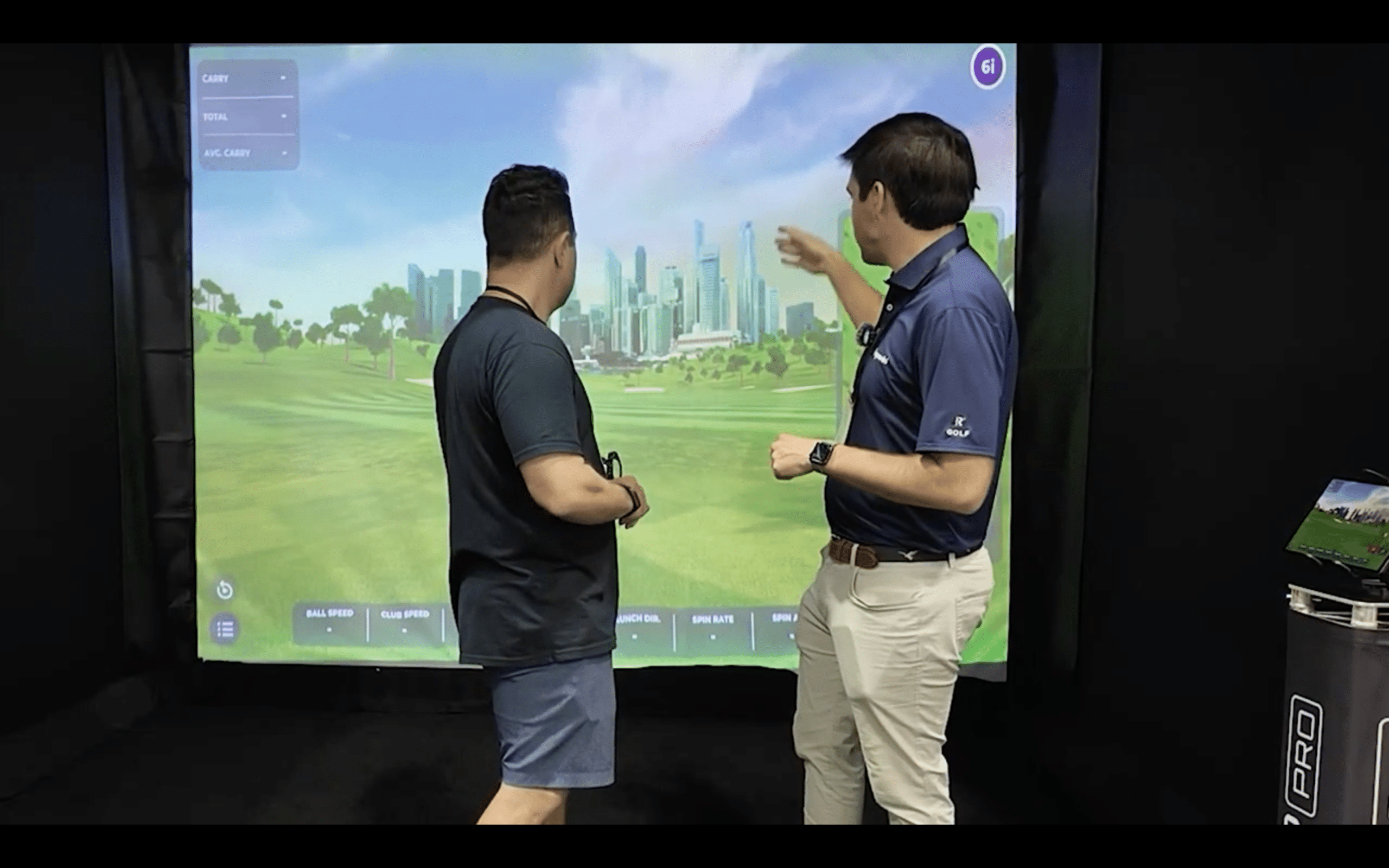 Two men analyzing golf simulator screen
