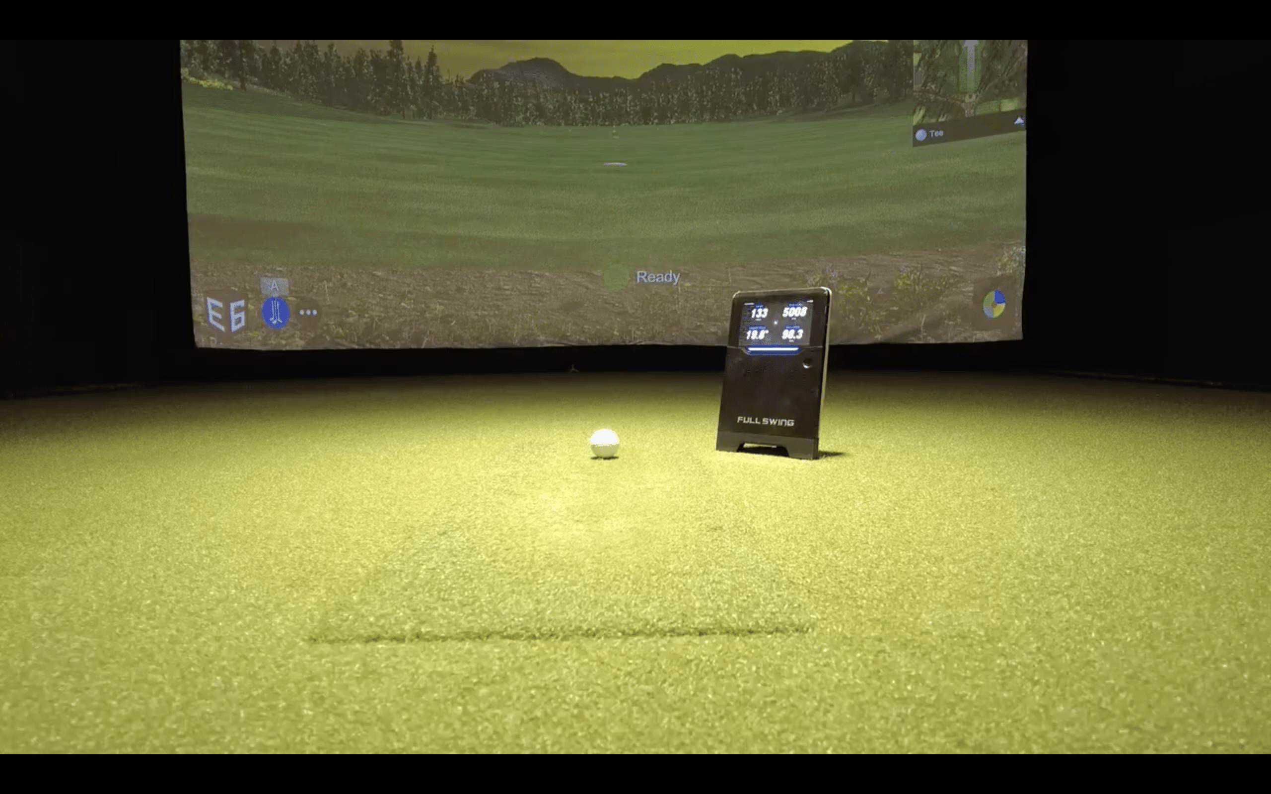 Indoor golf simulator with ball and monitor