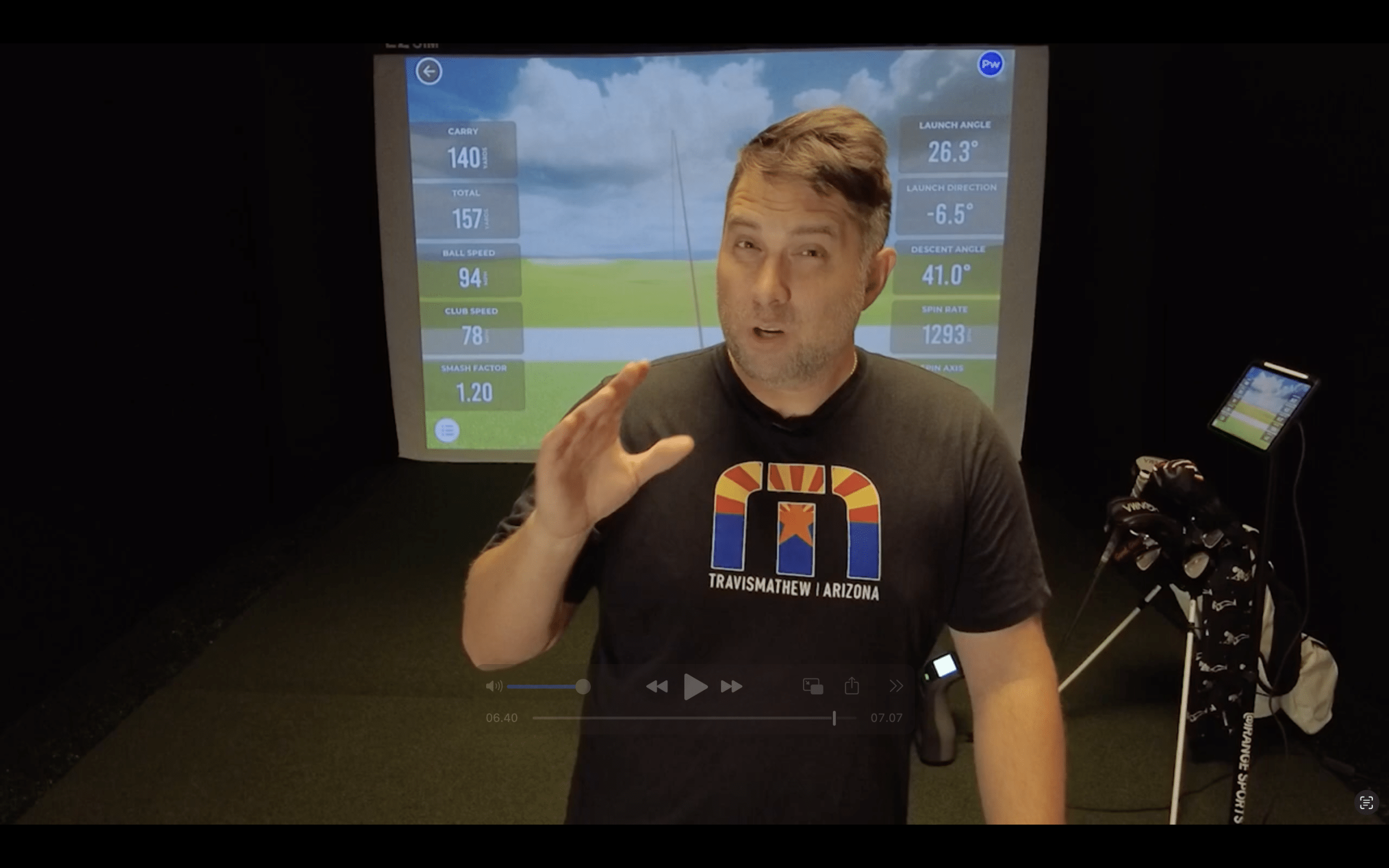 Man explaining golf swing analysis with simulator data