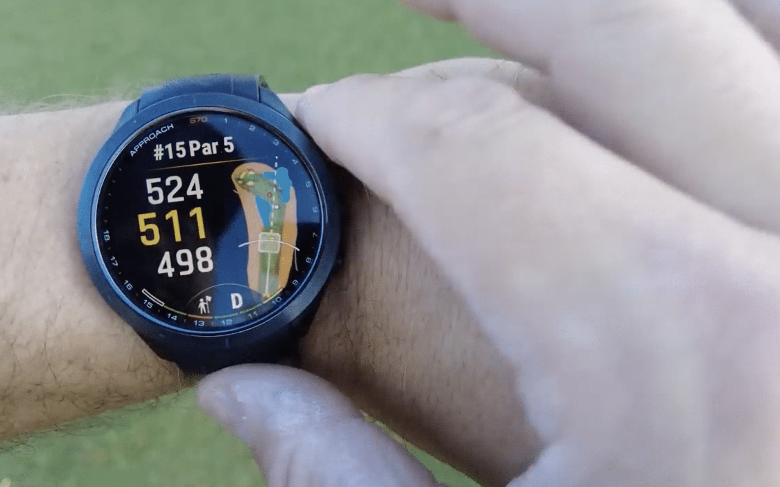 Golf GPS smartwatch showing hole distance on wrist