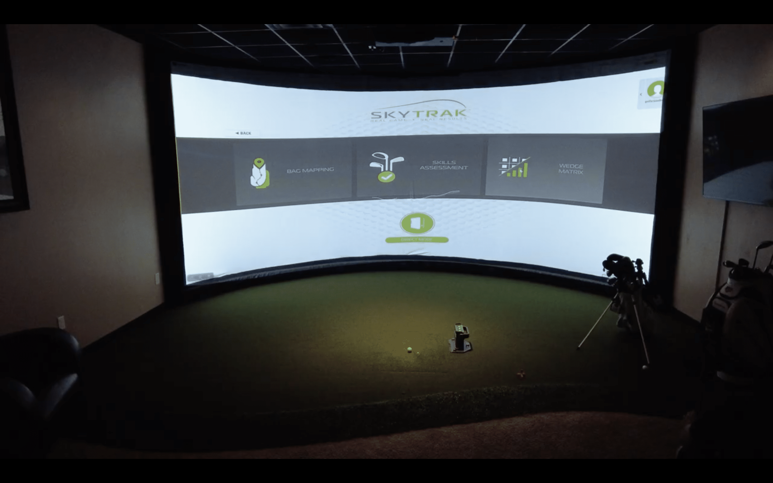 Indoor golf simulator with SkyTrak system display