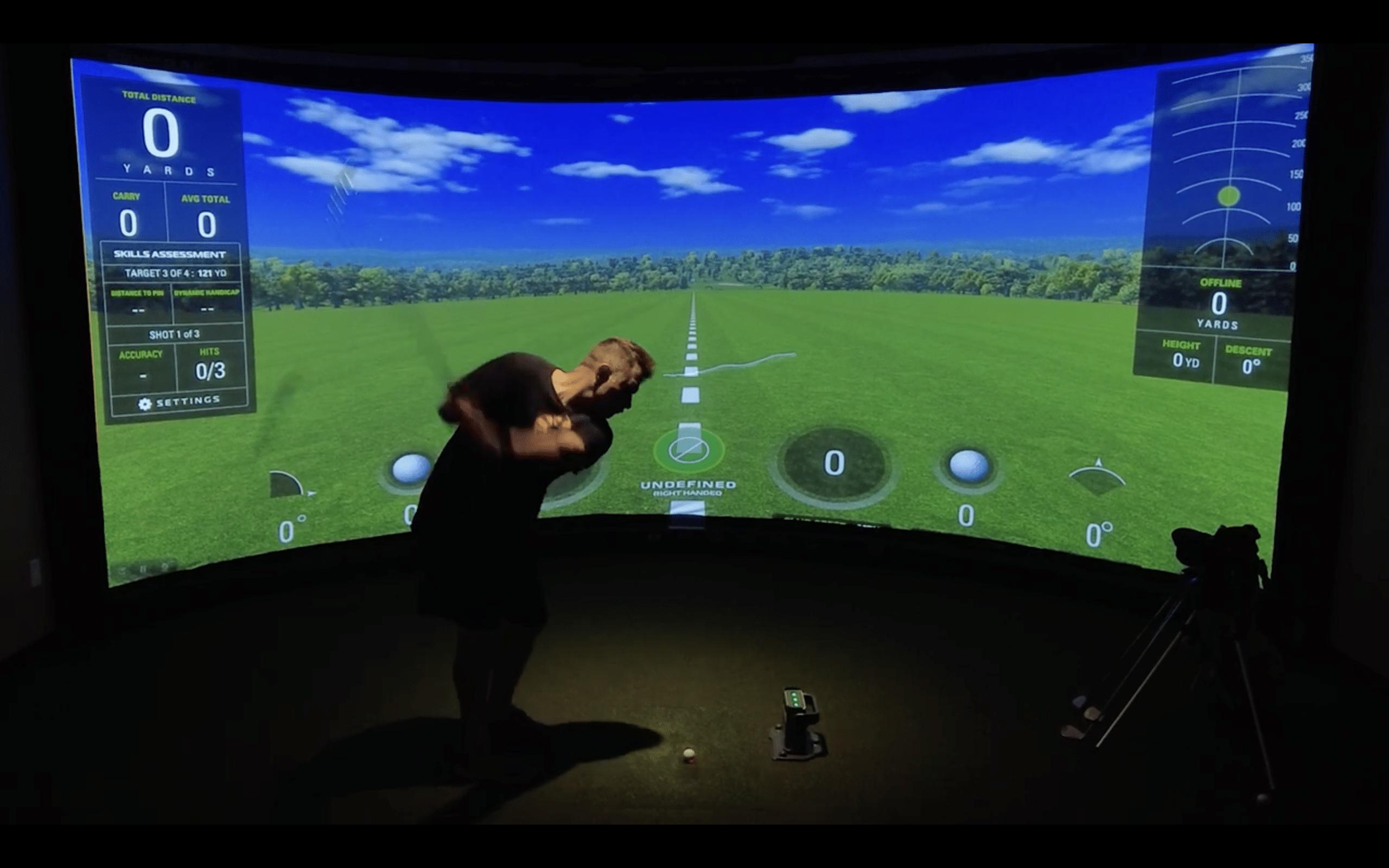 Man practicing golf swing in indoor simulator