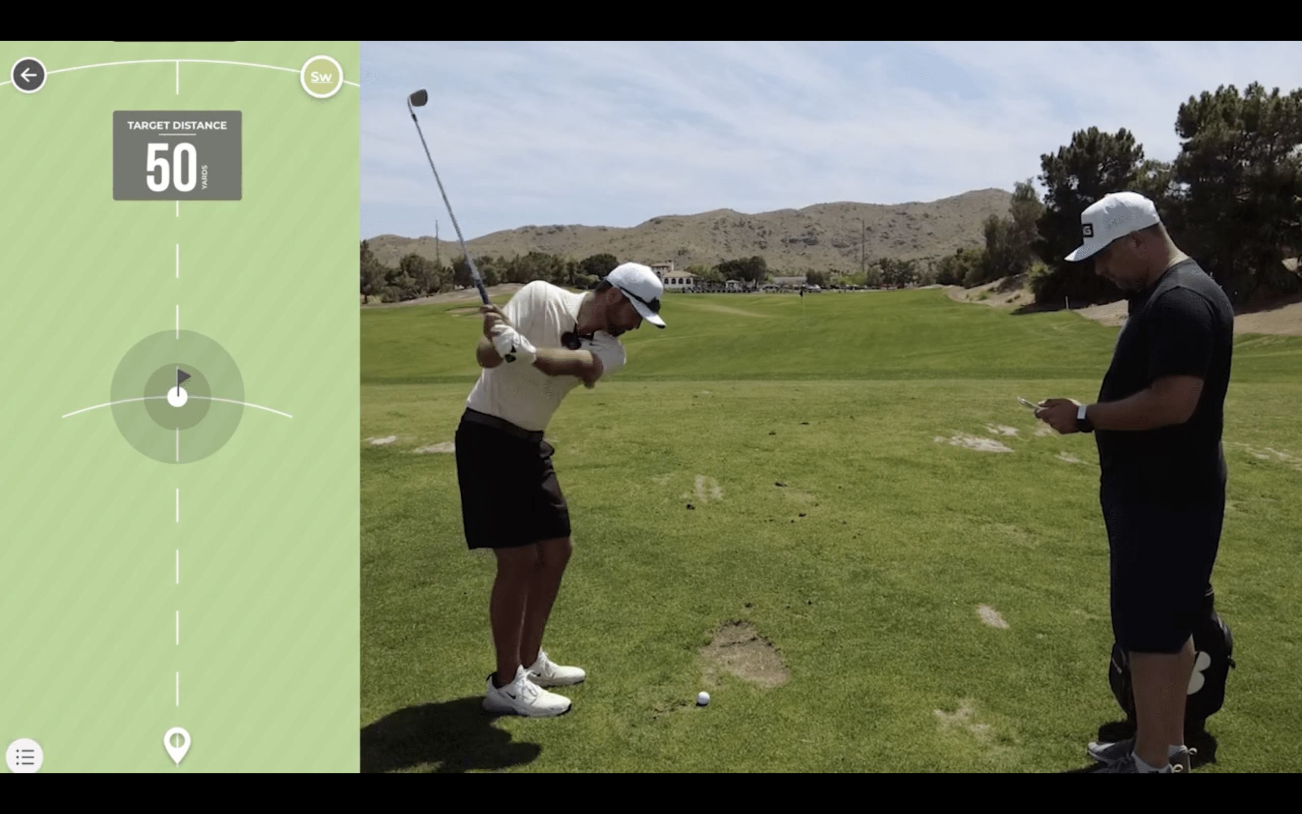 Golfer practicing swing on golf course with distance tracker