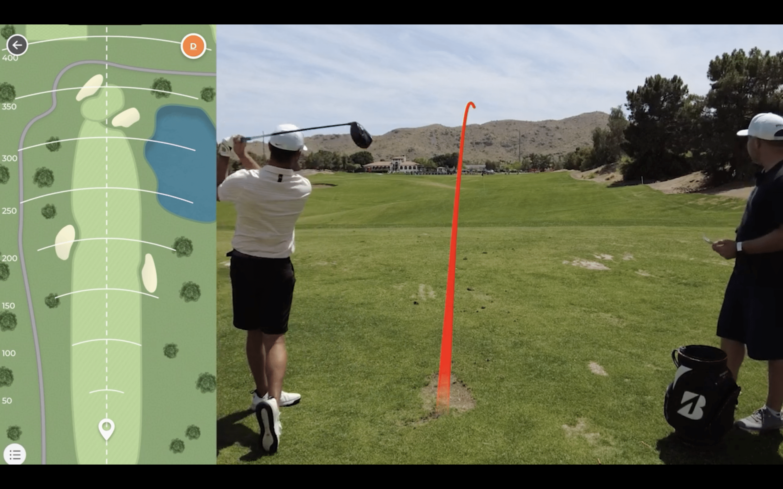 Golfer hits drive with shot tracer on course