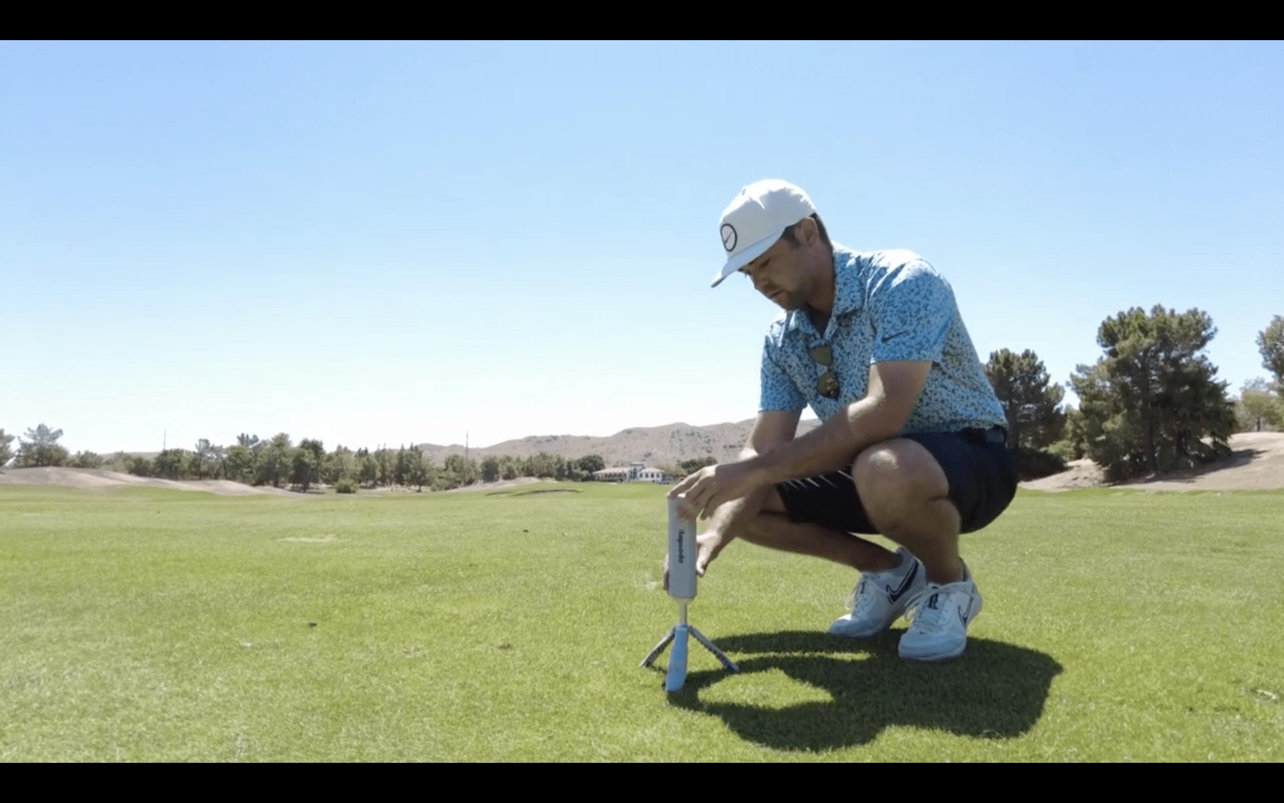 Man setting up camera on golf course