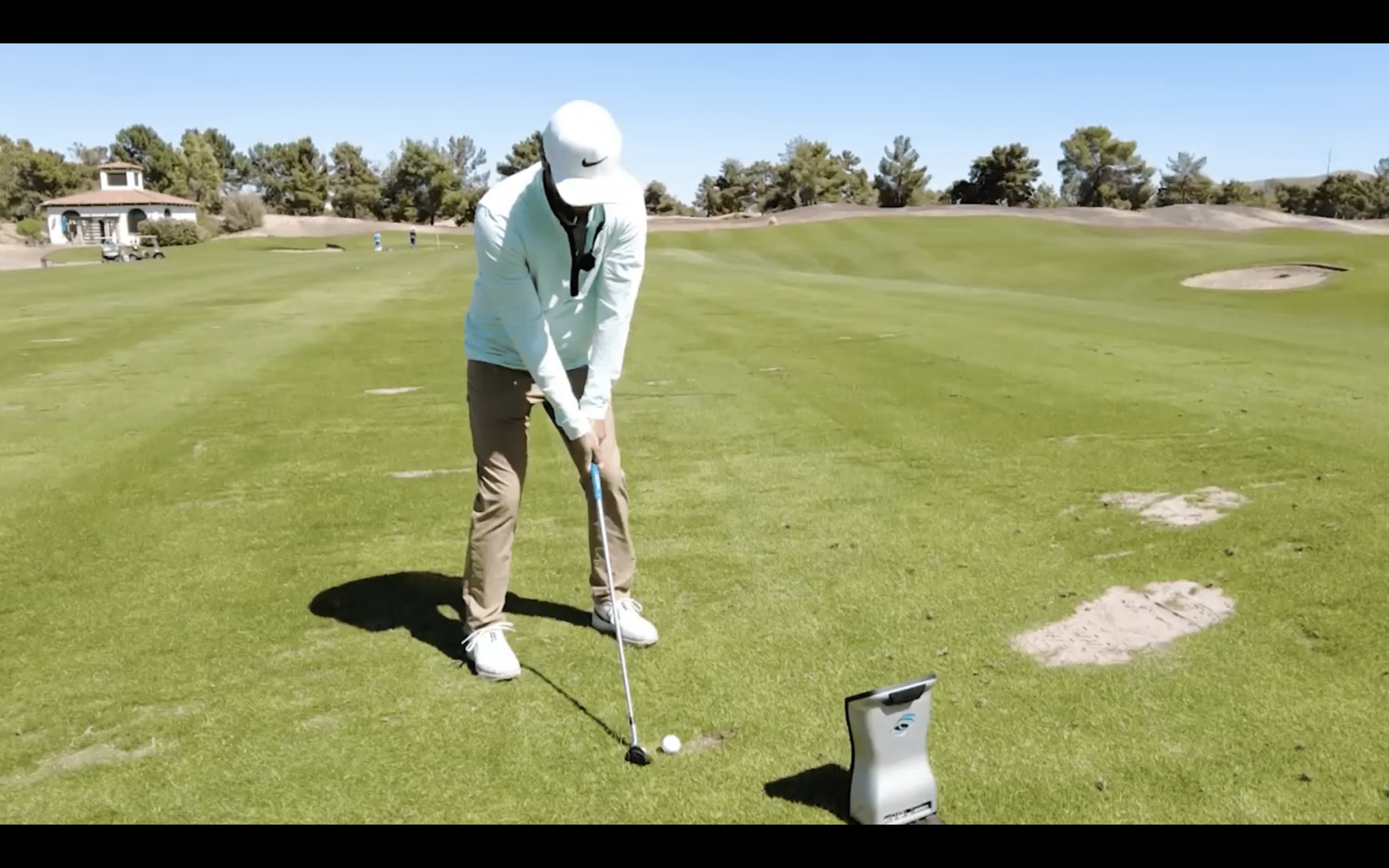 Golfer preparing to swing on sunny golf course
