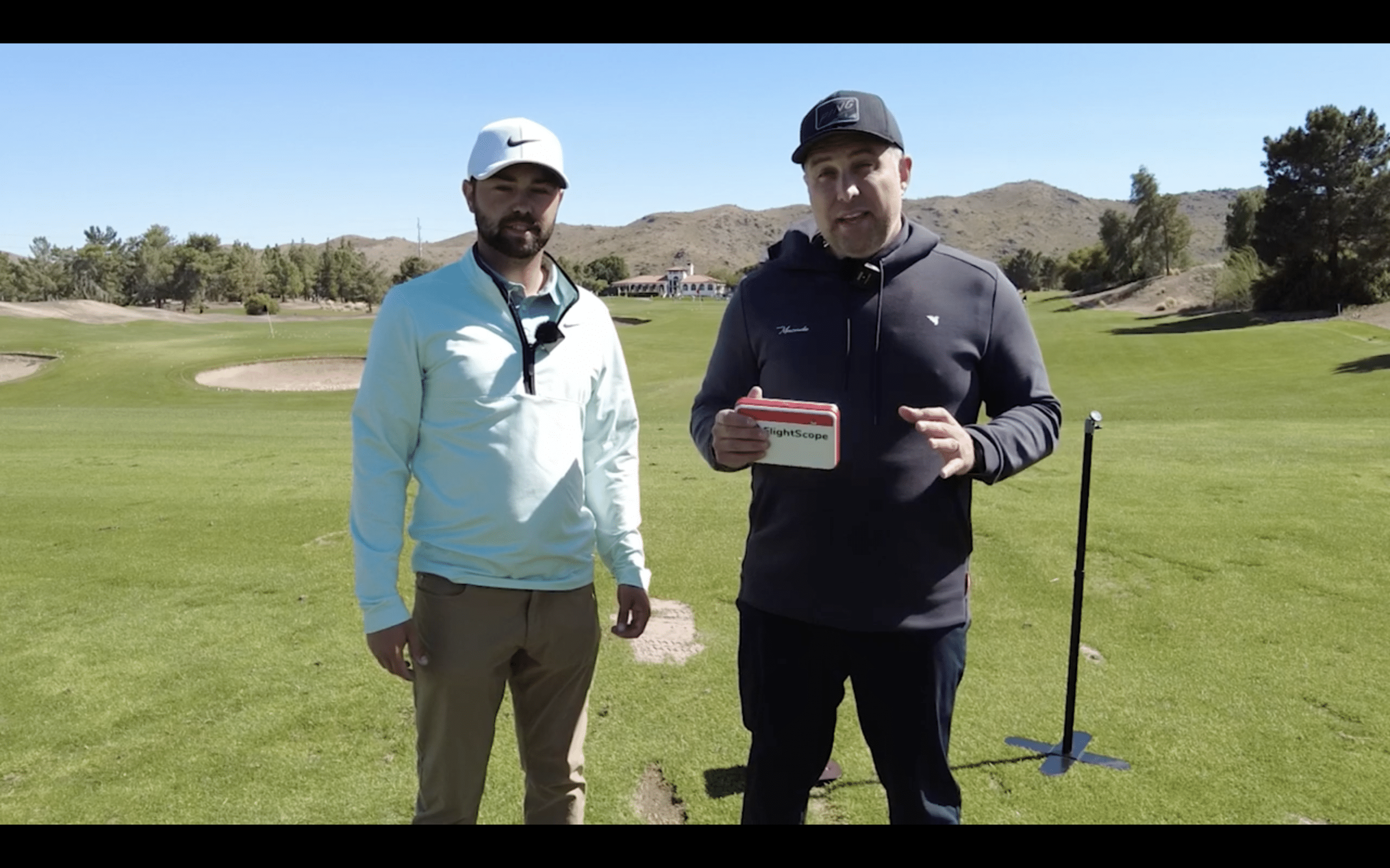 Two men standing on a golf course