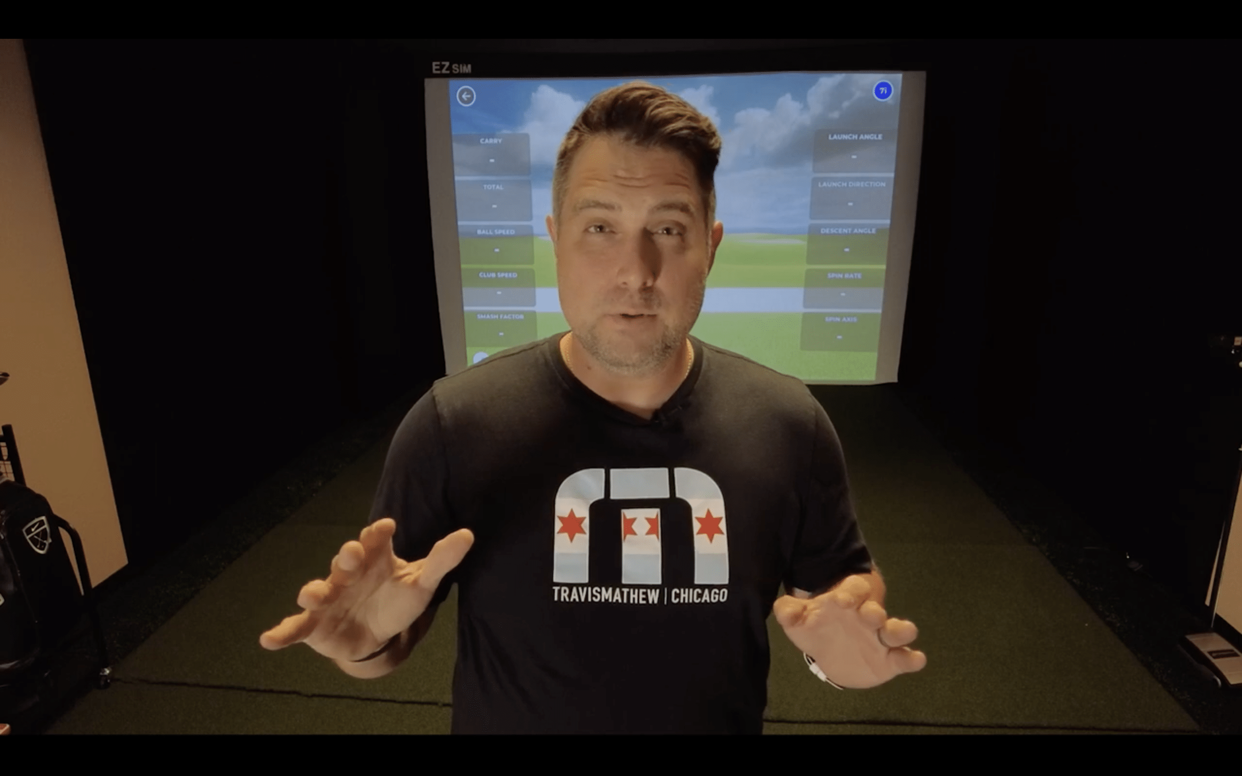 Man explaining golf simulator setup indoors