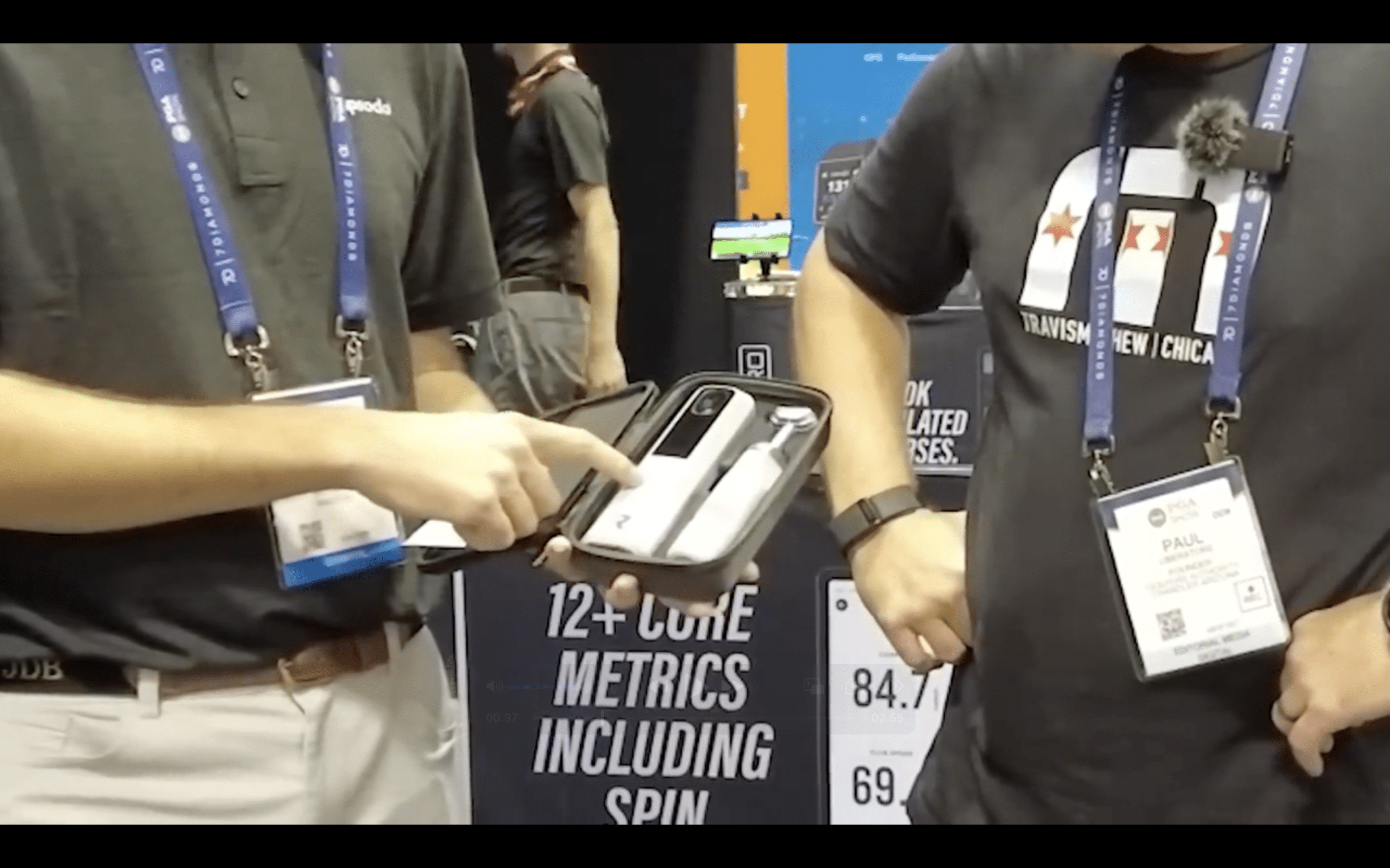 Person showing electronic device kit at trade show