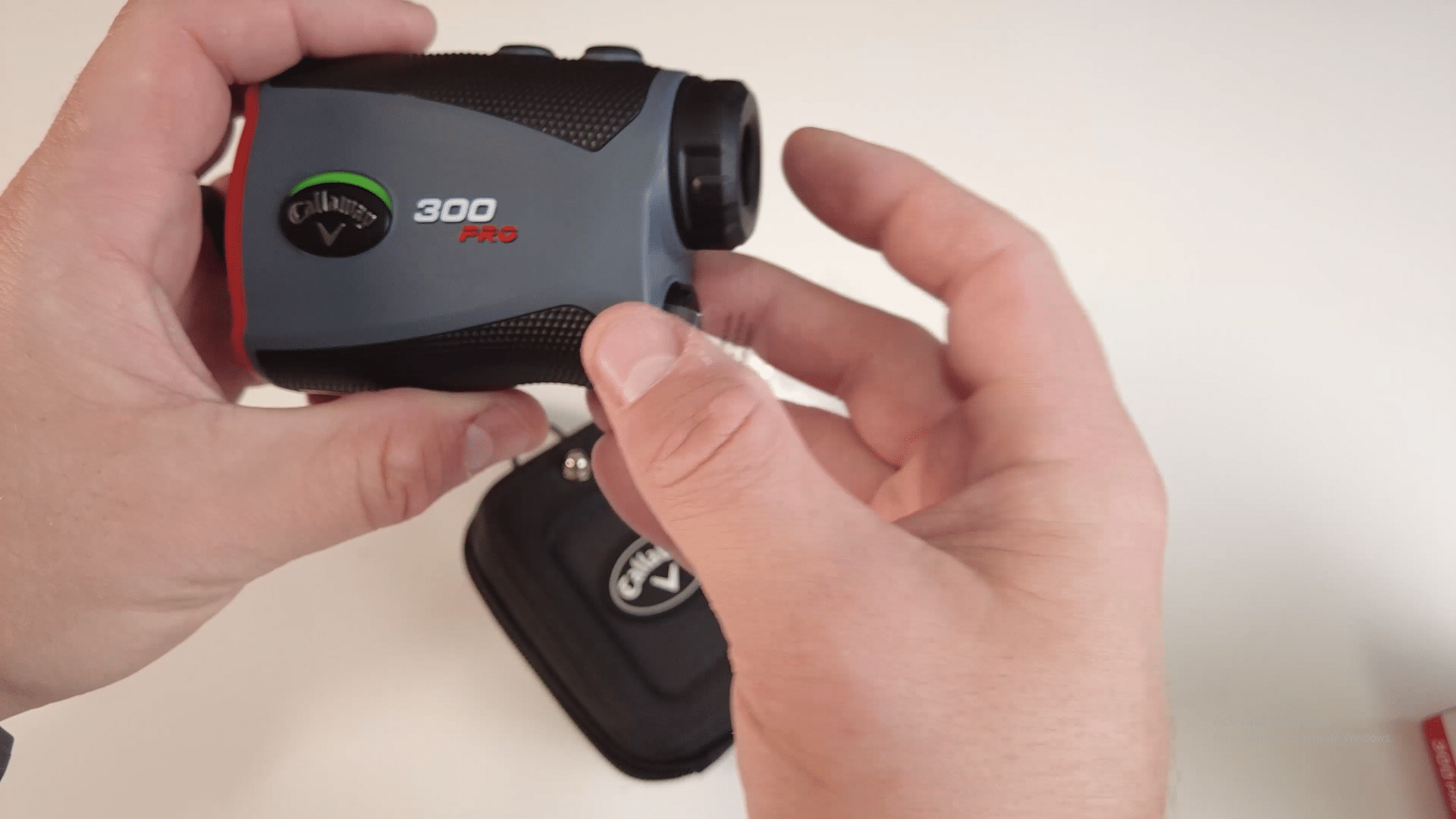 Person holding Callaway 300 Pro golf rangefinder