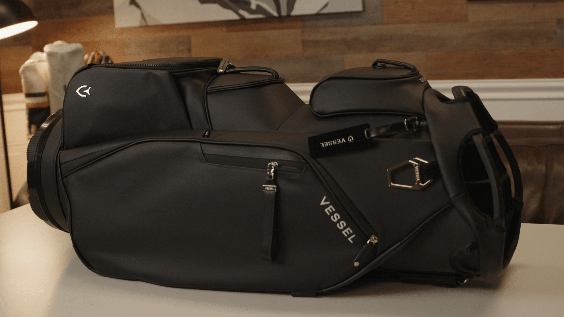 Black Vessel golf bag on indoor table