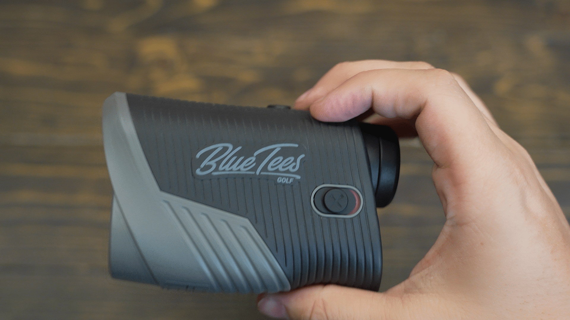 Hand holding Blue Tees golf rangefinder
