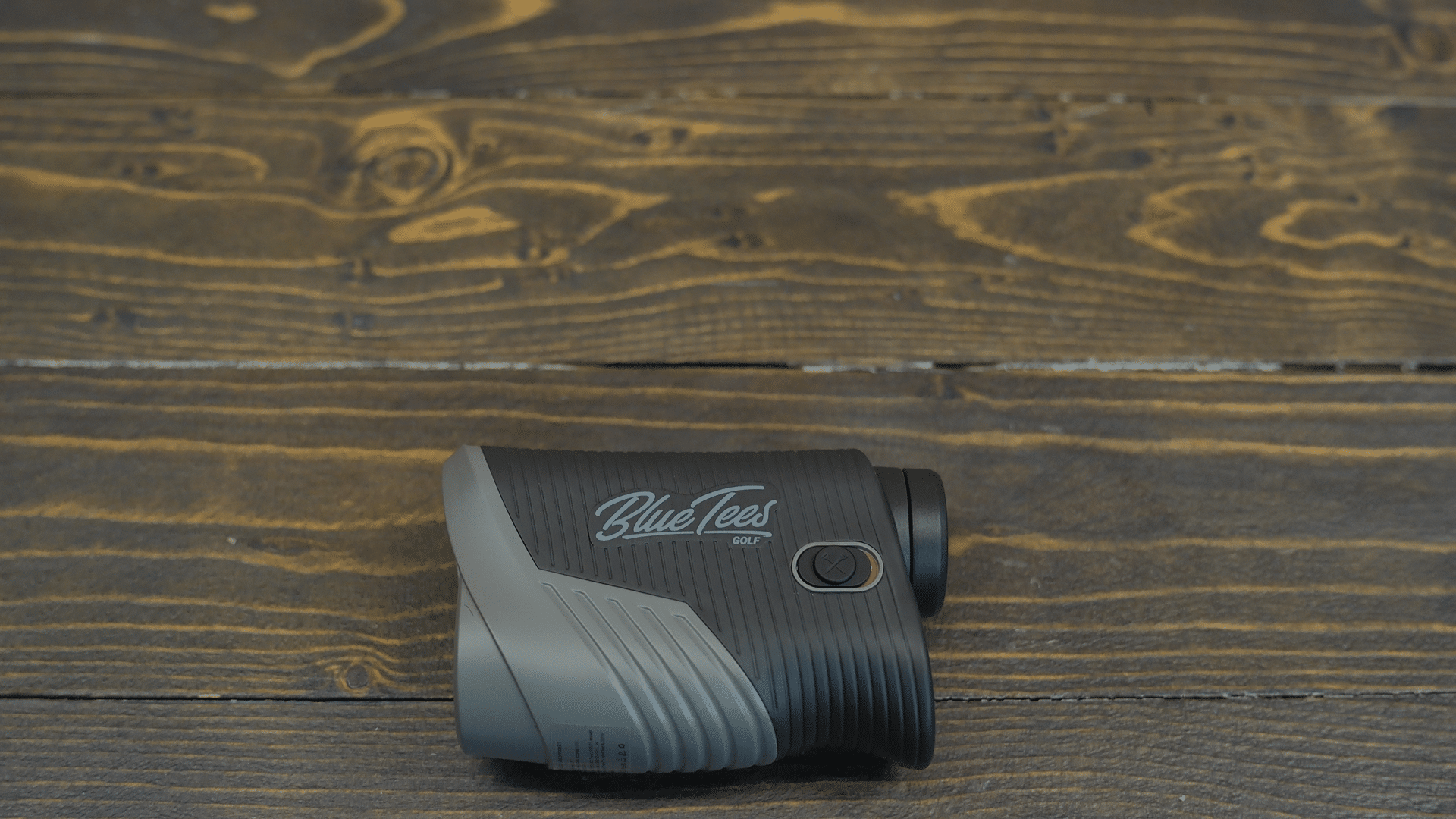 Blue Tees golf rangefinder on wooden surface