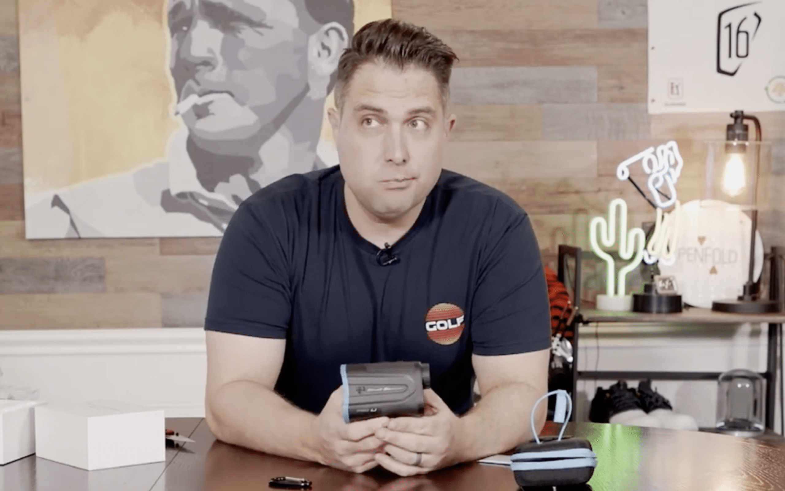Man holding golf rangefinder during product review